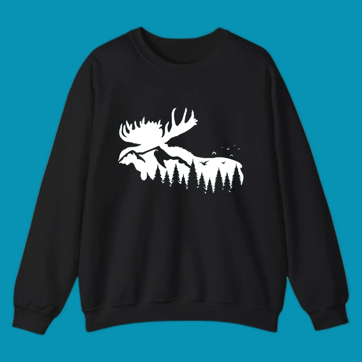 White silhouette of a moose with large antlers integrated into a forested mountain landscape with evergreen trees and flying birds against gray background.