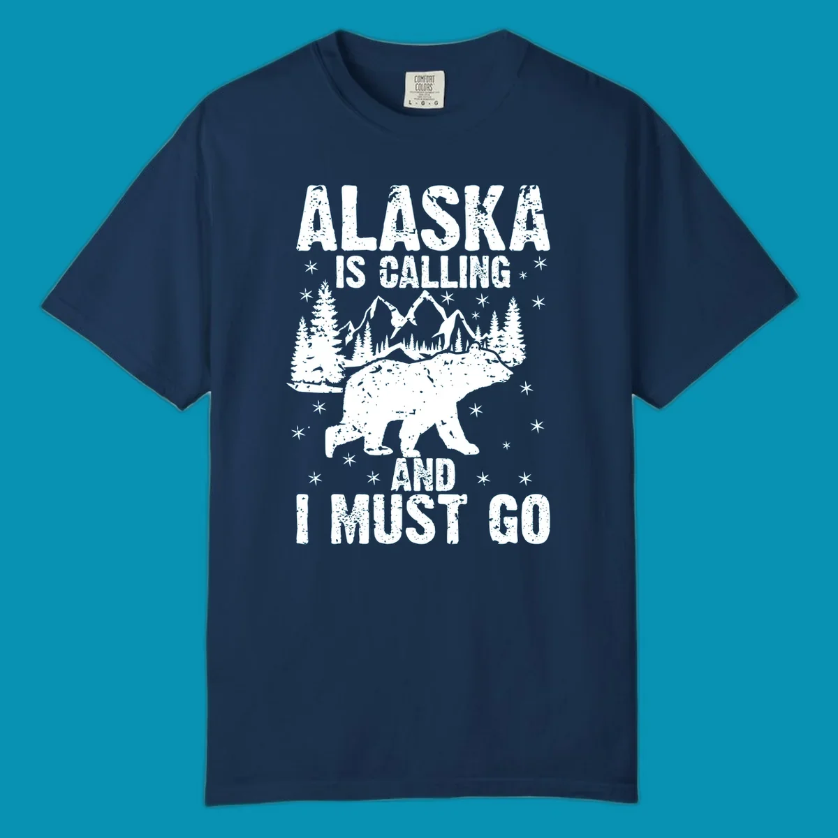 Distressed vintage design with polar bear in snowy mountains, text reads 'Alaska Is Calling And I Must Go'