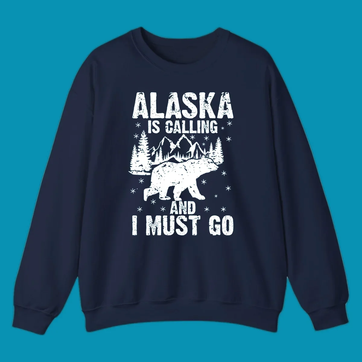 Distressed vintage design with polar bear in snowy mountains, text reads 'Alaska Is Calling And I Must Go'
