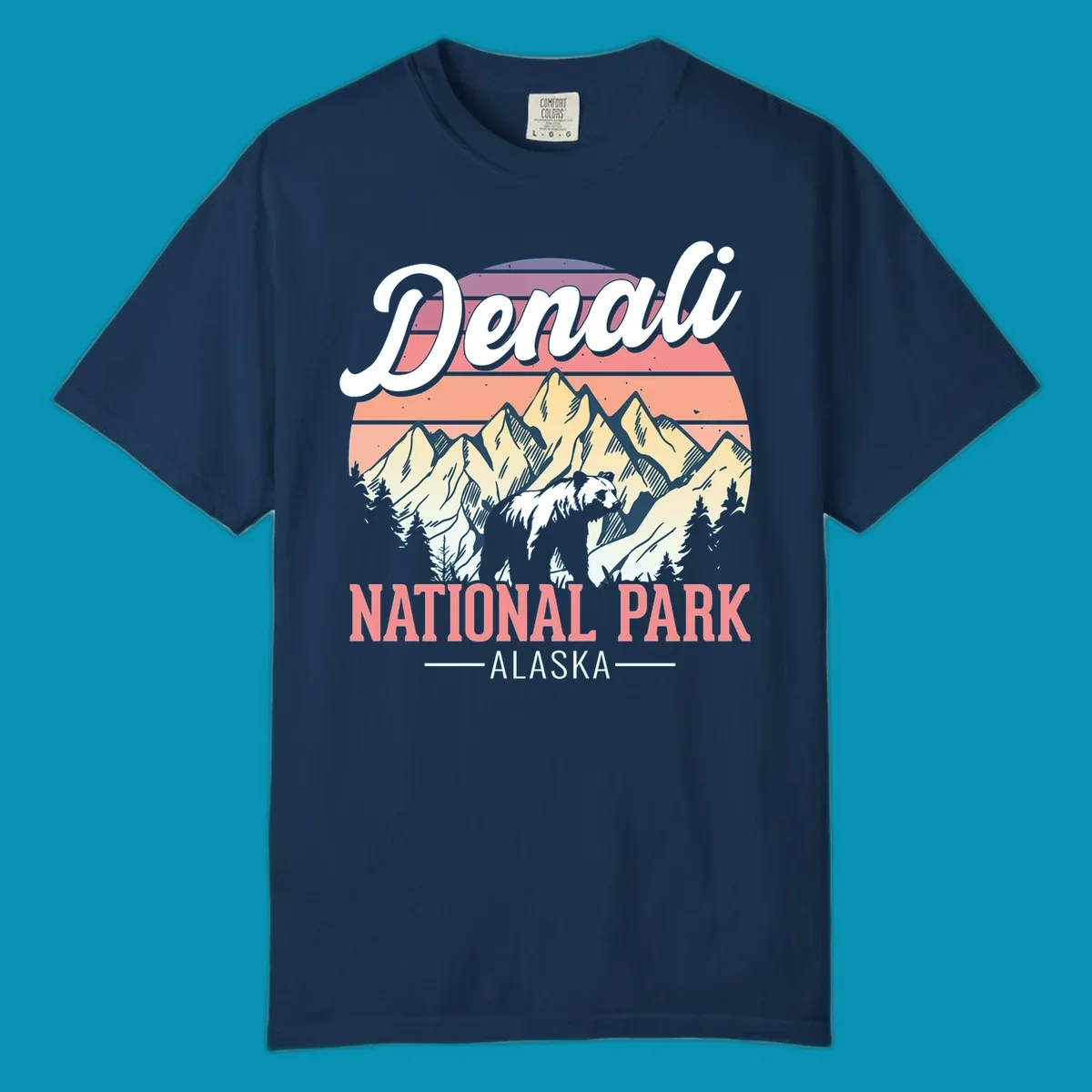 Retro vintage illustration of Denali National Park with snow-capped mountain peaks against a warm coral and peach sunset gradient background with text.
