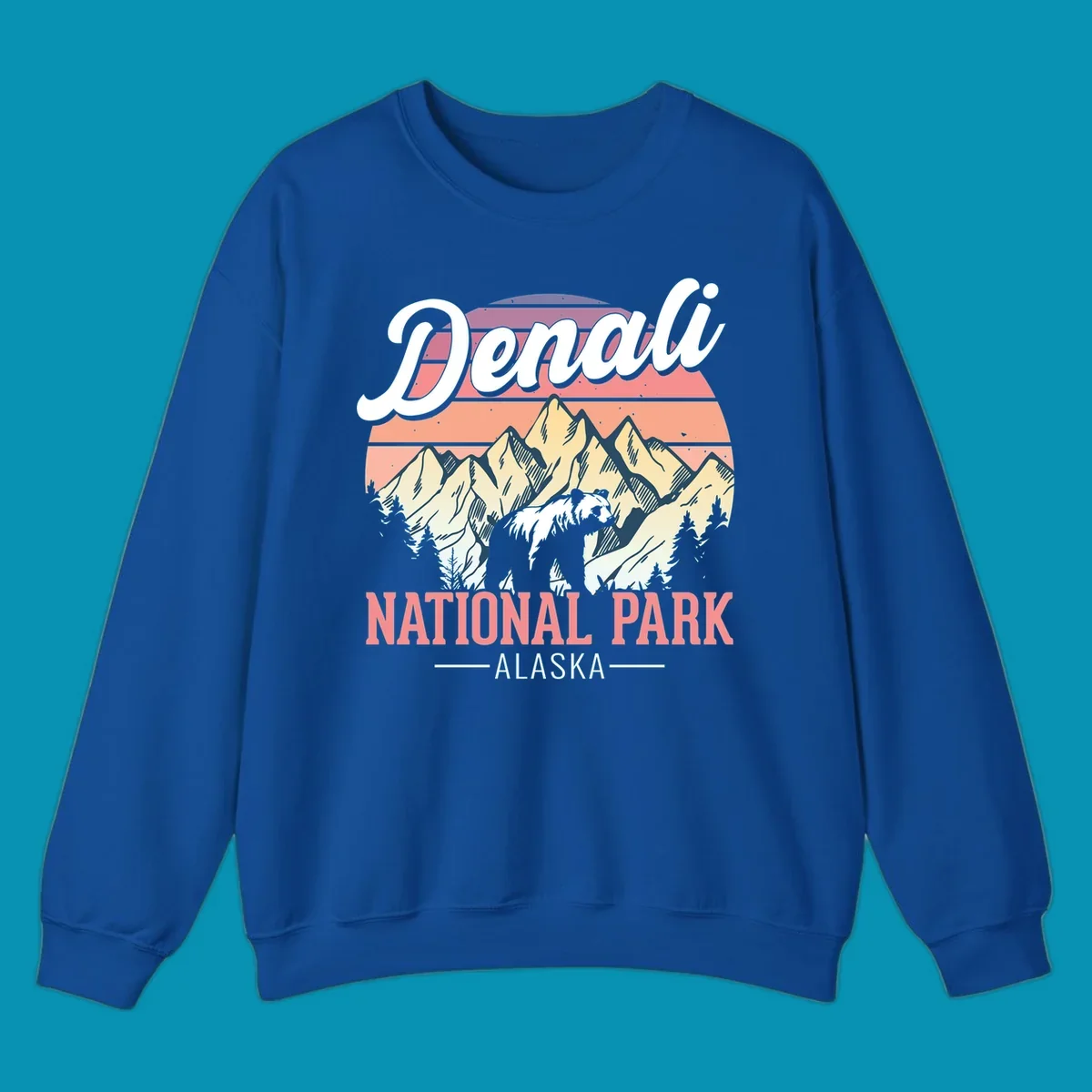 Retro vintage illustration of Denali National Park with snow-capped mountain peaks against a warm coral and peach sunset gradient background with text.