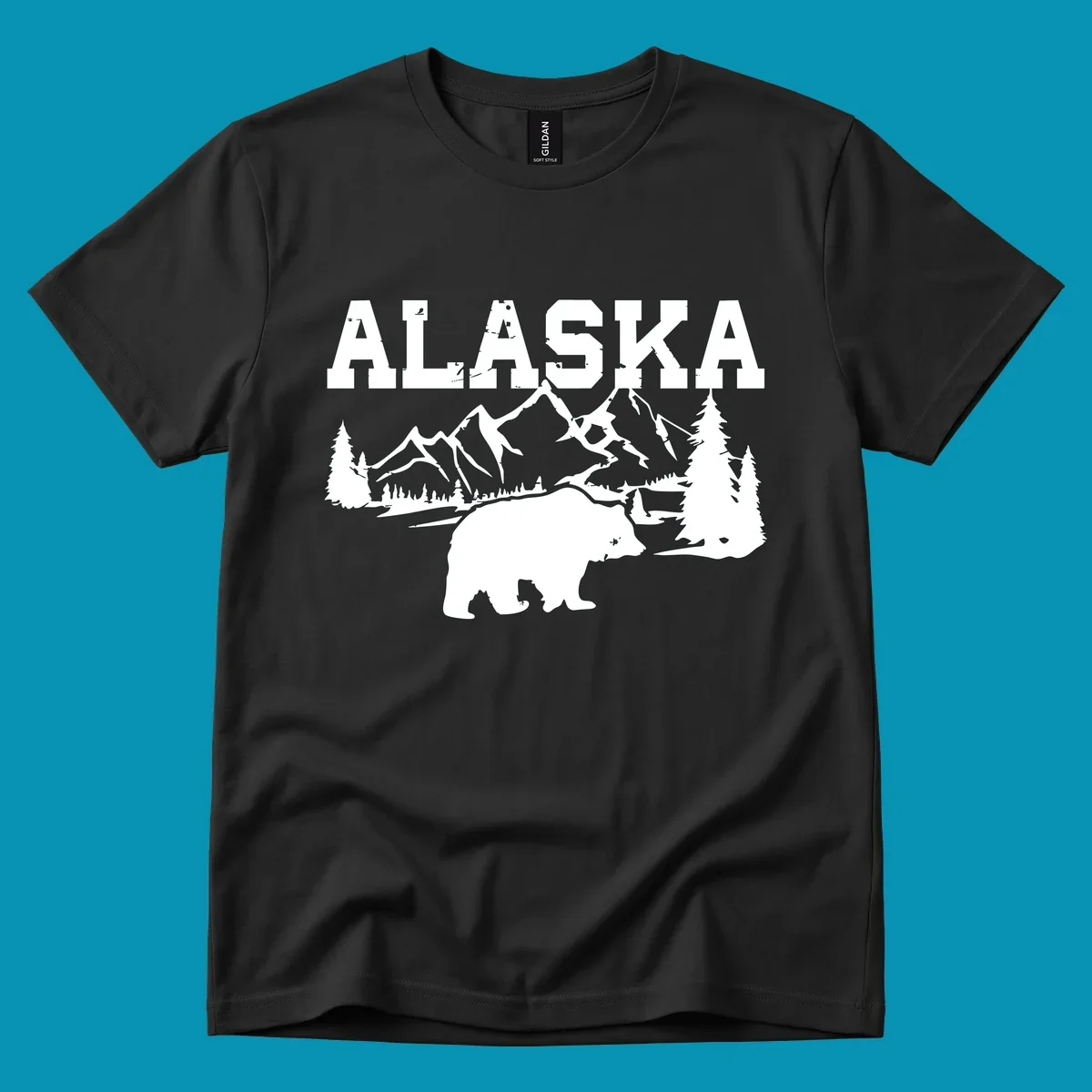 White silhouette illustration of a bear with mountains, evergreen trees, and river landscape under Alaska text on gray background