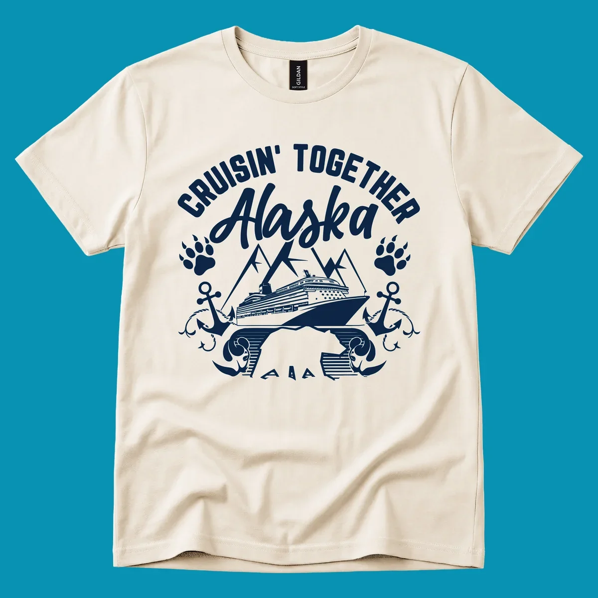 White nautical design on gray background featuring cruise ship between mountains with paw prints and anchors, text reads 'Cruisin' Together Alaska'