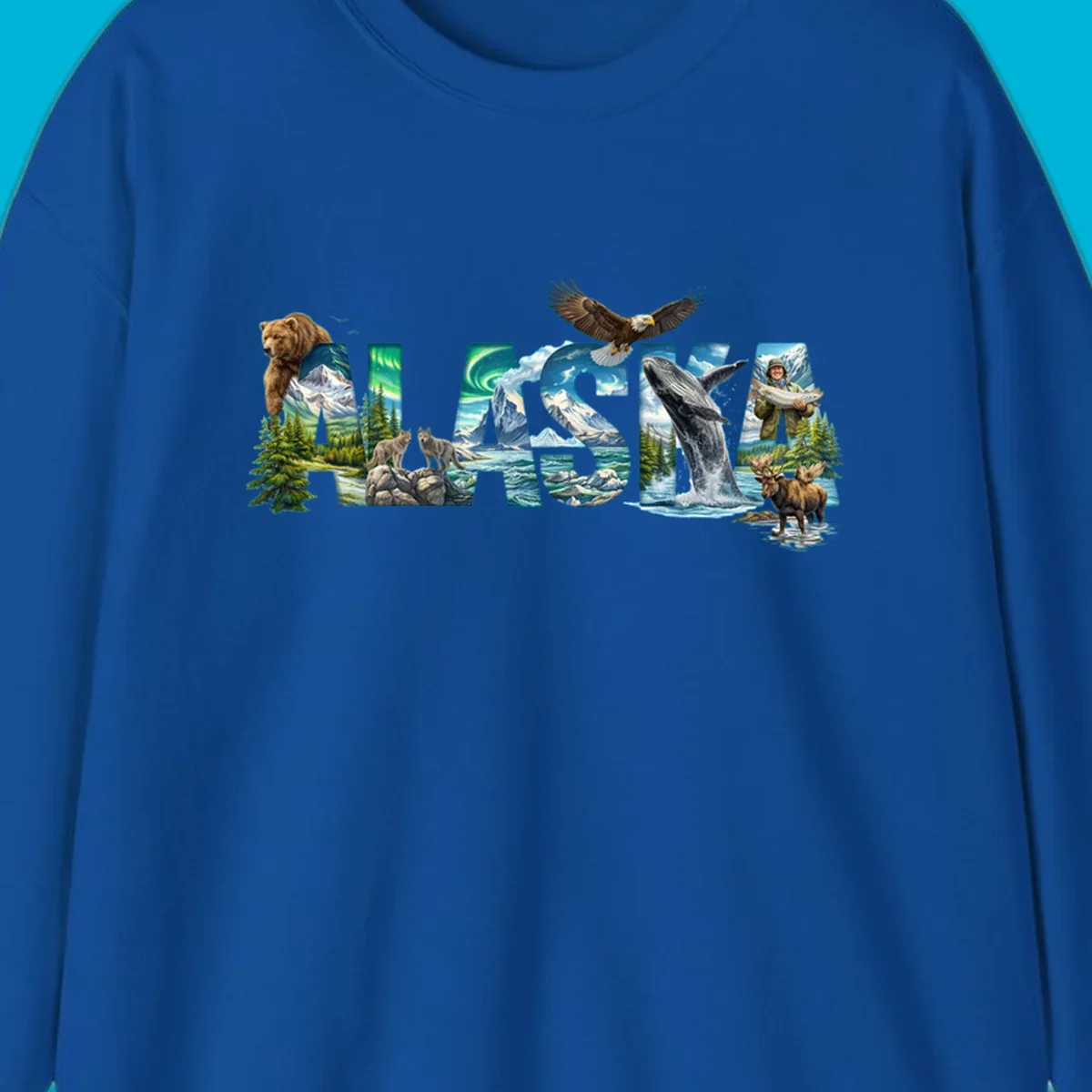 An illustrated text design spelling "ALASKA" with images of a grizzly, mountains, northern lights, wolves, ocean, bald eagle, whale, fisherman, and moose. This alaska-wildlife-scenic-text design captures the state's natural beauty.