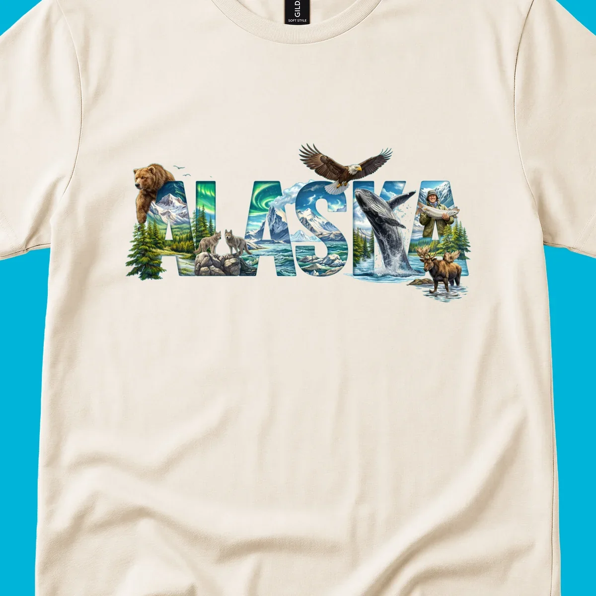 An illustrated text design spelling "ALASKA" with images of a grizzly, mountains, northern lights, wolves, ocean, bald eagle, whale, fisherman, and moose. This alaska-wildlife-scenic-text design captures the state's natural beauty.