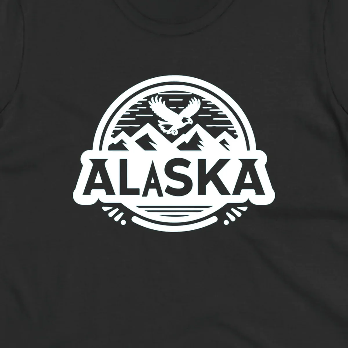 An oval badge design with a bald eagle flying above mountains and water, and the word ALASKA in bold text; alaska-eagle-mountain-badge.