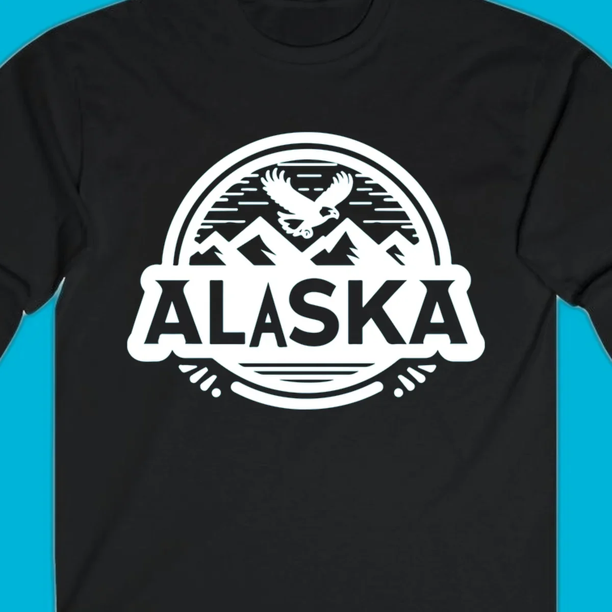 An oval badge design with a bald eagle flying above mountains and water, and the word ALASKA in bold text; alaska-eagle-mountain-badge.