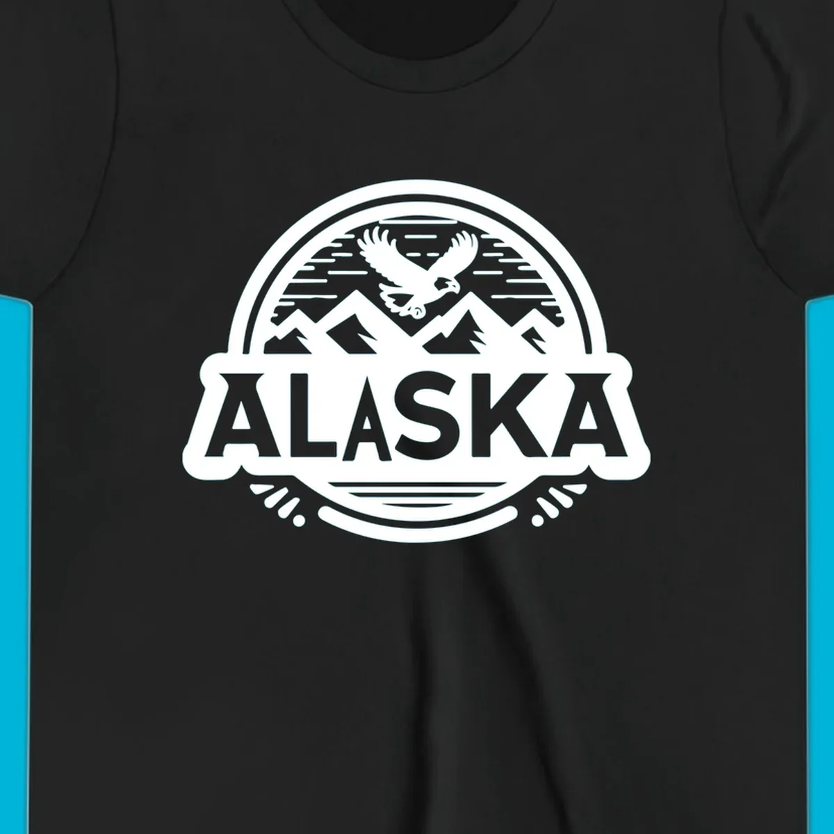 An oval badge design with a bald eagle flying above mountains and water, and the word ALASKA in bold text; alaska-eagle-mountain-badge.