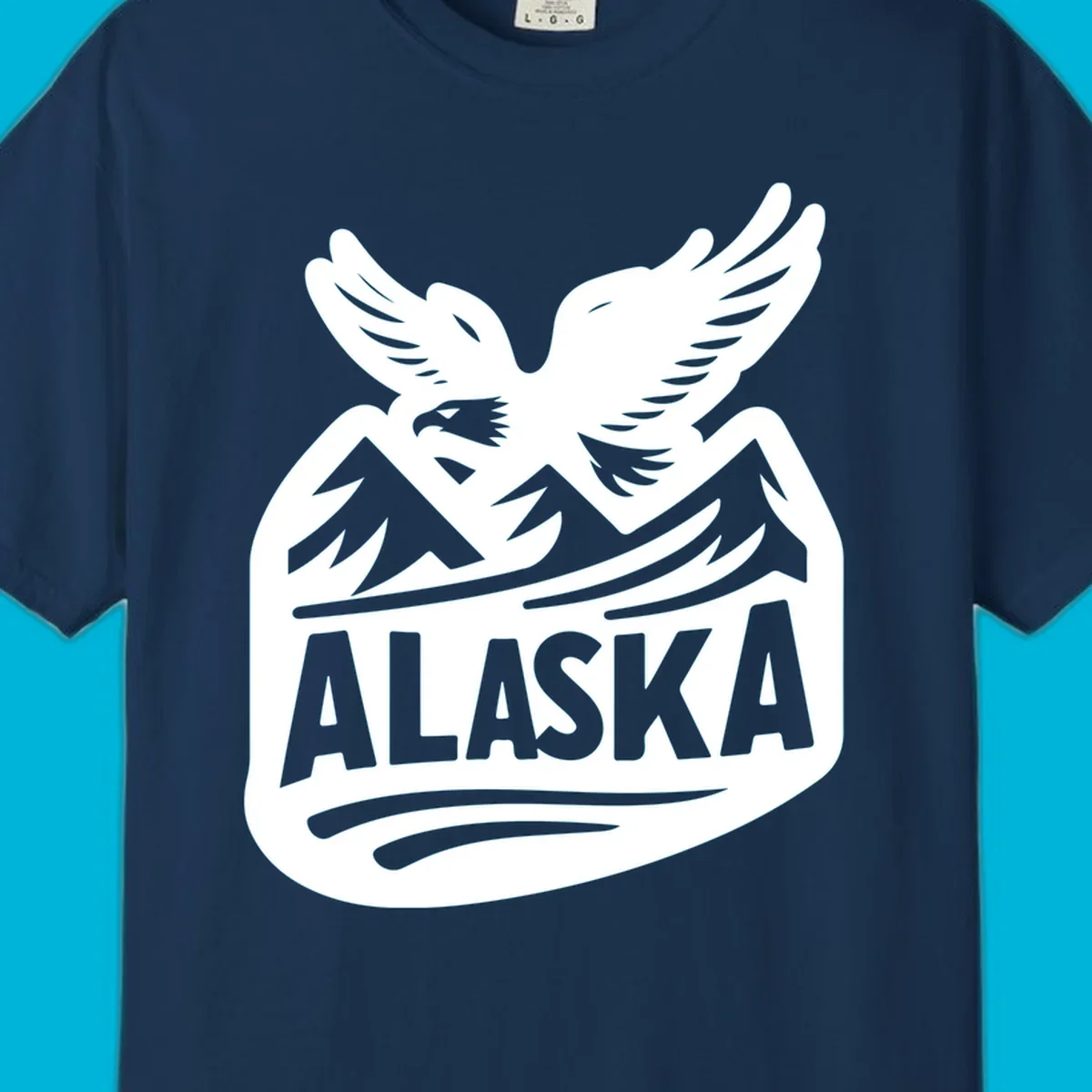 A white and dark blue badge design showing a flying eagle over mountain peaks with "ALASKA" text, for a cruise souvenir.