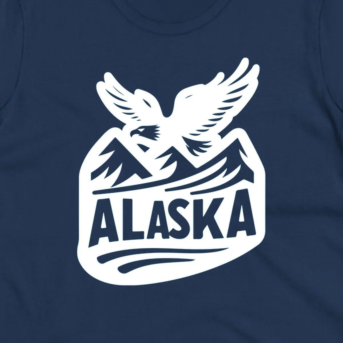 A white and dark blue badge design showing a flying eagle over mountain peaks with "ALASKA" text, for a cruise souvenir.