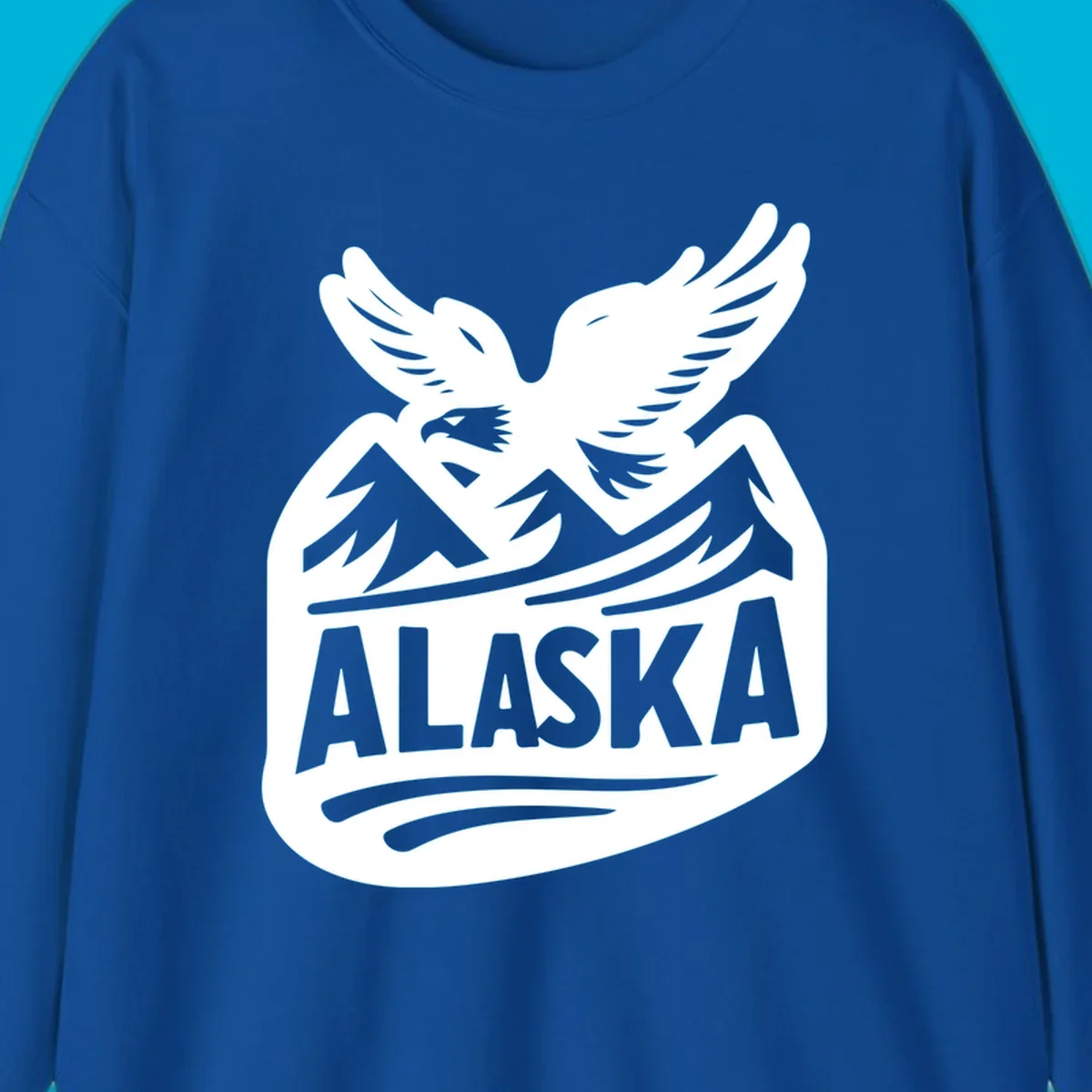 A white and dark blue badge design showing a flying eagle over mountain peaks with "ALASKA" text, for a cruise souvenir.
