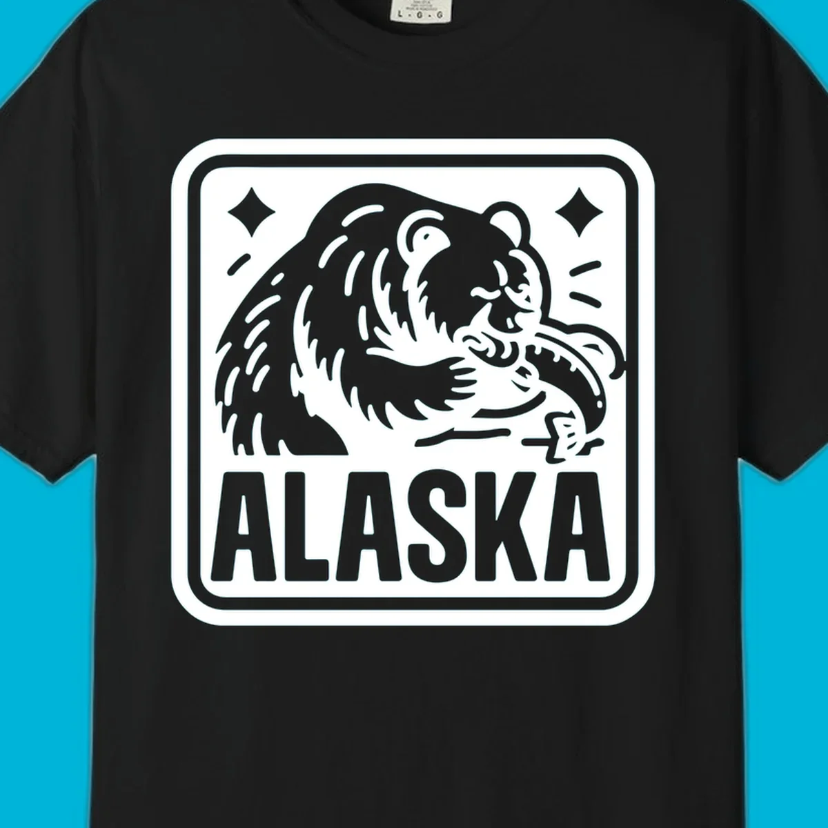 A white alaskan grizzly salmon fishing illustration within a rectangular badge, with 'ALASKA' text.
