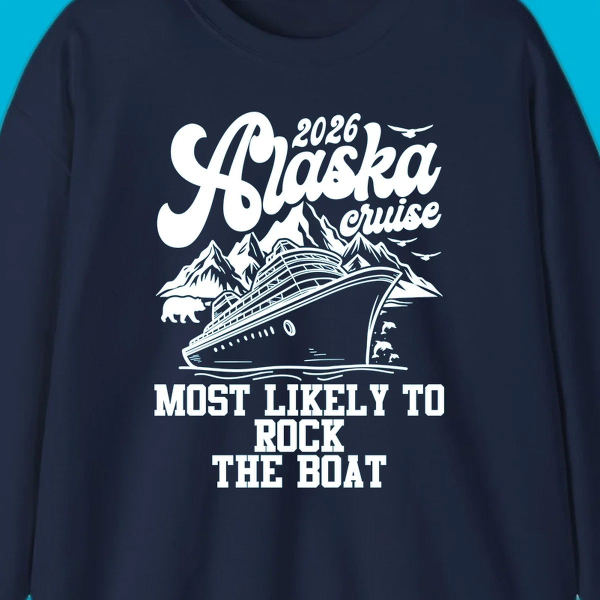 An illustrated Alaska cruise rock the boat design with a ship, mountains, bear, dolphins, and birds.
