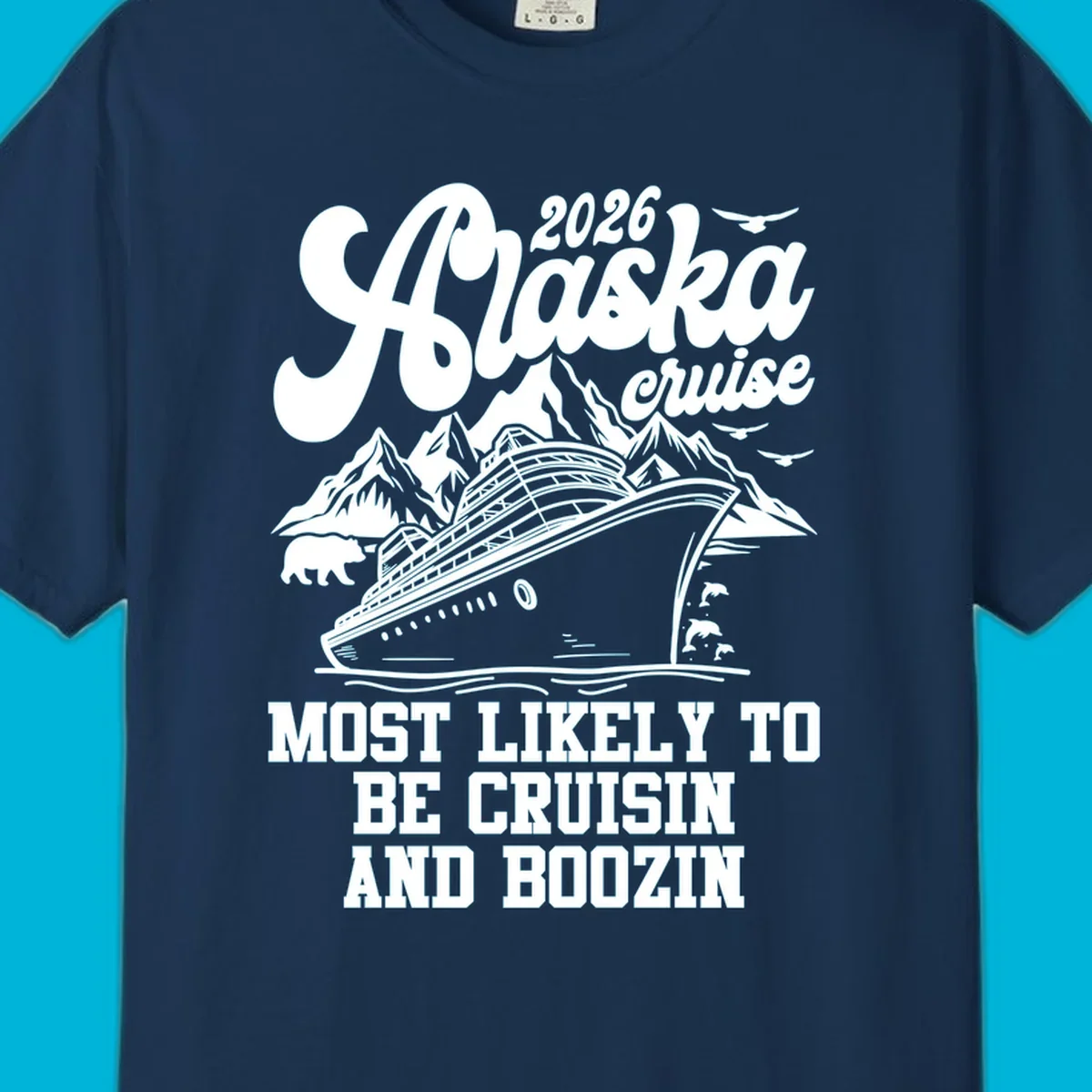 An illustrated white (or dark blue) Alaska cruise ship design with mountains, a bear, and marine life, featuring "alaska-cruisin-boozin" text.