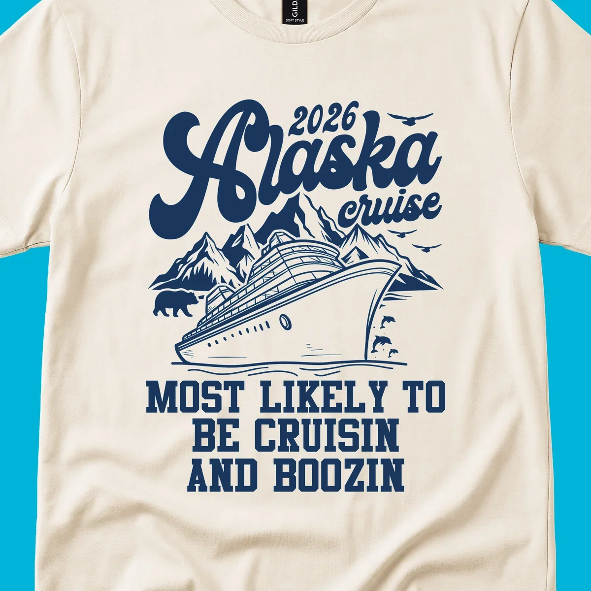 An illustrated white (or dark blue) Alaska cruise ship design with mountains, a bear, and marine life, featuring "alaska-cruisin-boozin" text.