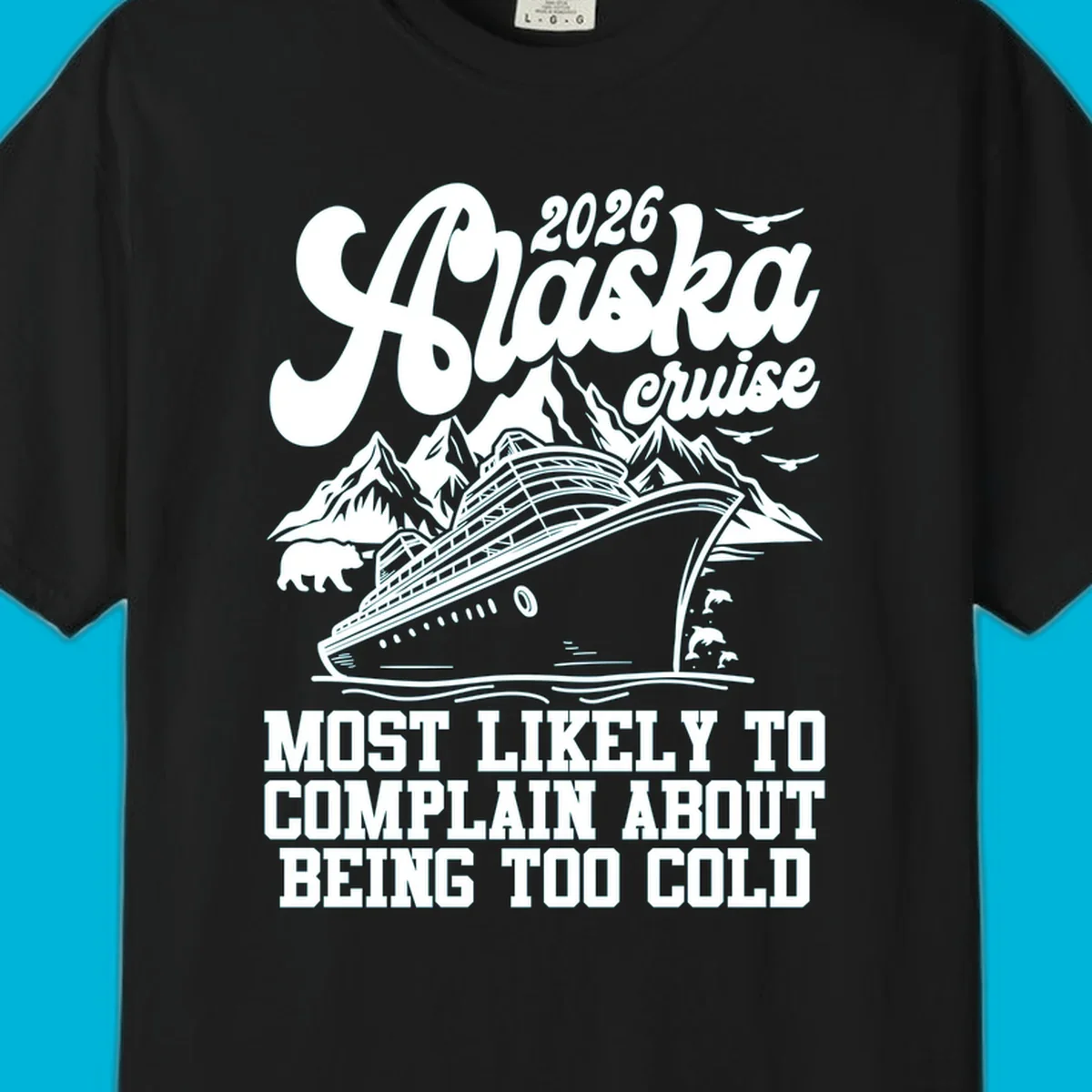 A white design on a black background of a cruise ship, mountains, bear, dolphins, and text "2026 Alaska cruise MOST LIKELY TO COMPLAIN ABOUT BEING TOO COLD".