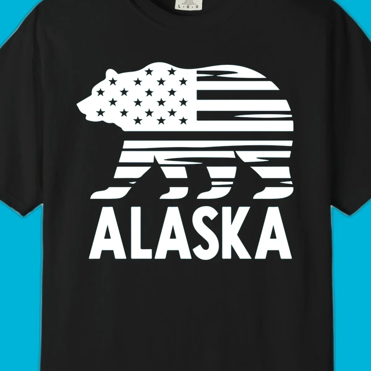 A white bear silhouette filled with the American flag and the text ALASKA. Represents an alaska-flag-bear.