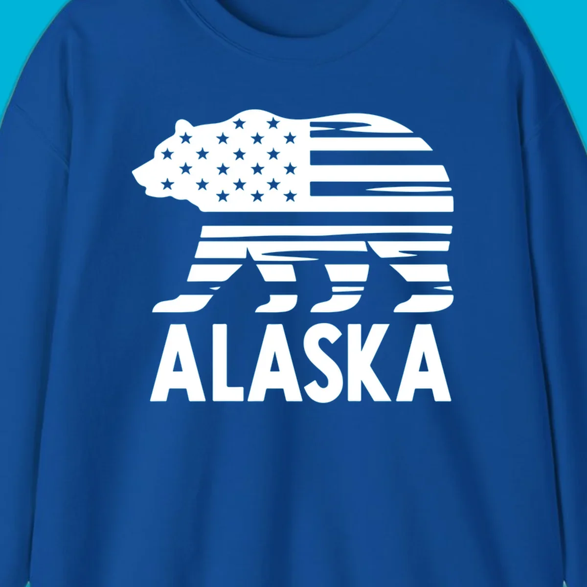 A white bear silhouette filled with the American flag and the text ALASKA. Represents an alaska-flag-bear.