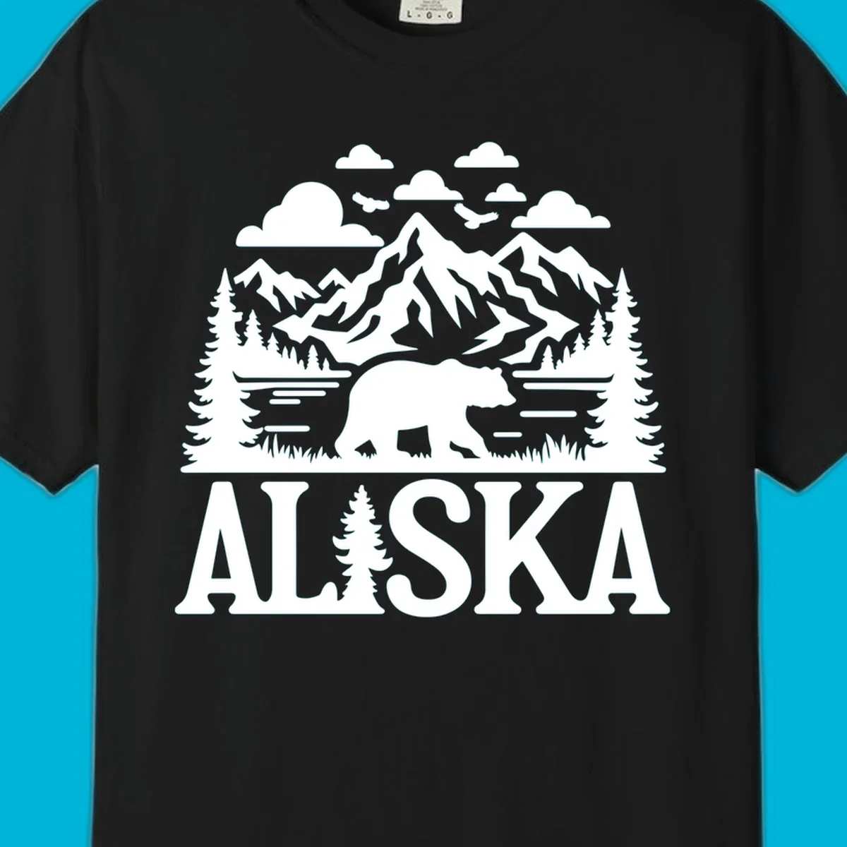 Graphic of an alaska-bear-mountain-view with a bear, mountains, forest, a lake, clouds, and birds, with 'ALASKA' text.