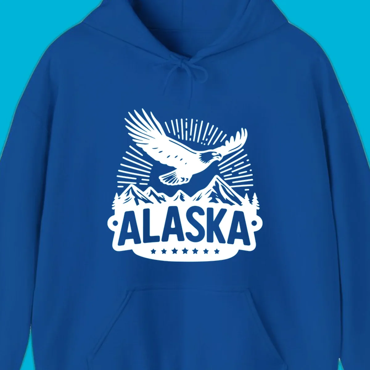 Vintage style Alaska eagle mountain view design with a soaring bald eagle over mountains and pine trees, with ALASKA text.