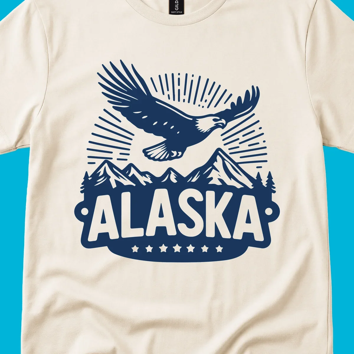 Vintage style Alaska eagle mountain view design with a soaring bald eagle over mountains and pine trees, with ALASKA text.