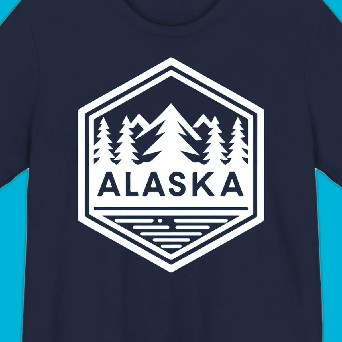 An Alaska mountain lake badge design in a hexagon shape, showing mountains, pine trees, and a lake below the ALASKA text.