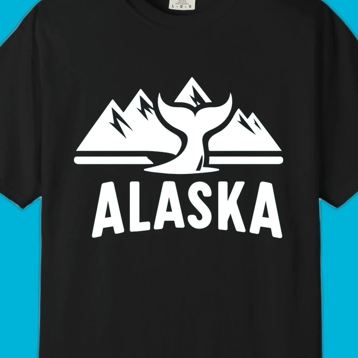 A scenic Alaska mountains whale tail design with three peaks and a whale's fluke above the word ALASKA.
