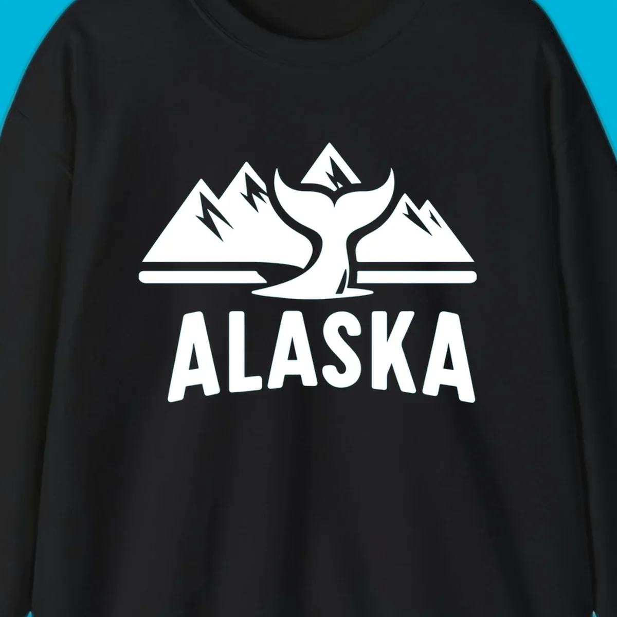 A scenic Alaska mountains whale tail design with three peaks and a whale's fluke above the word ALASKA.