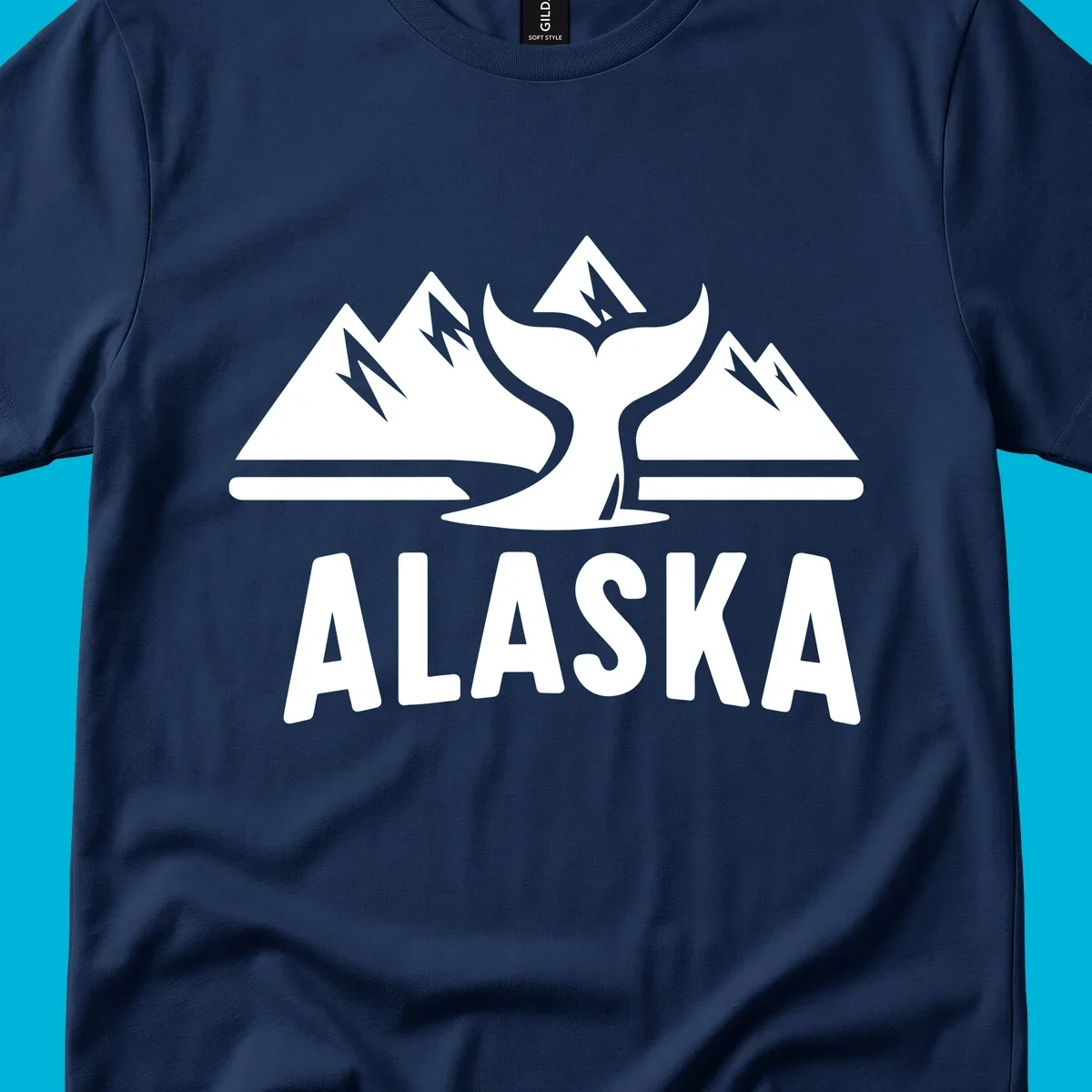 A scenic Alaska mountains whale tail design with three peaks and a whale's fluke above the word ALASKA.