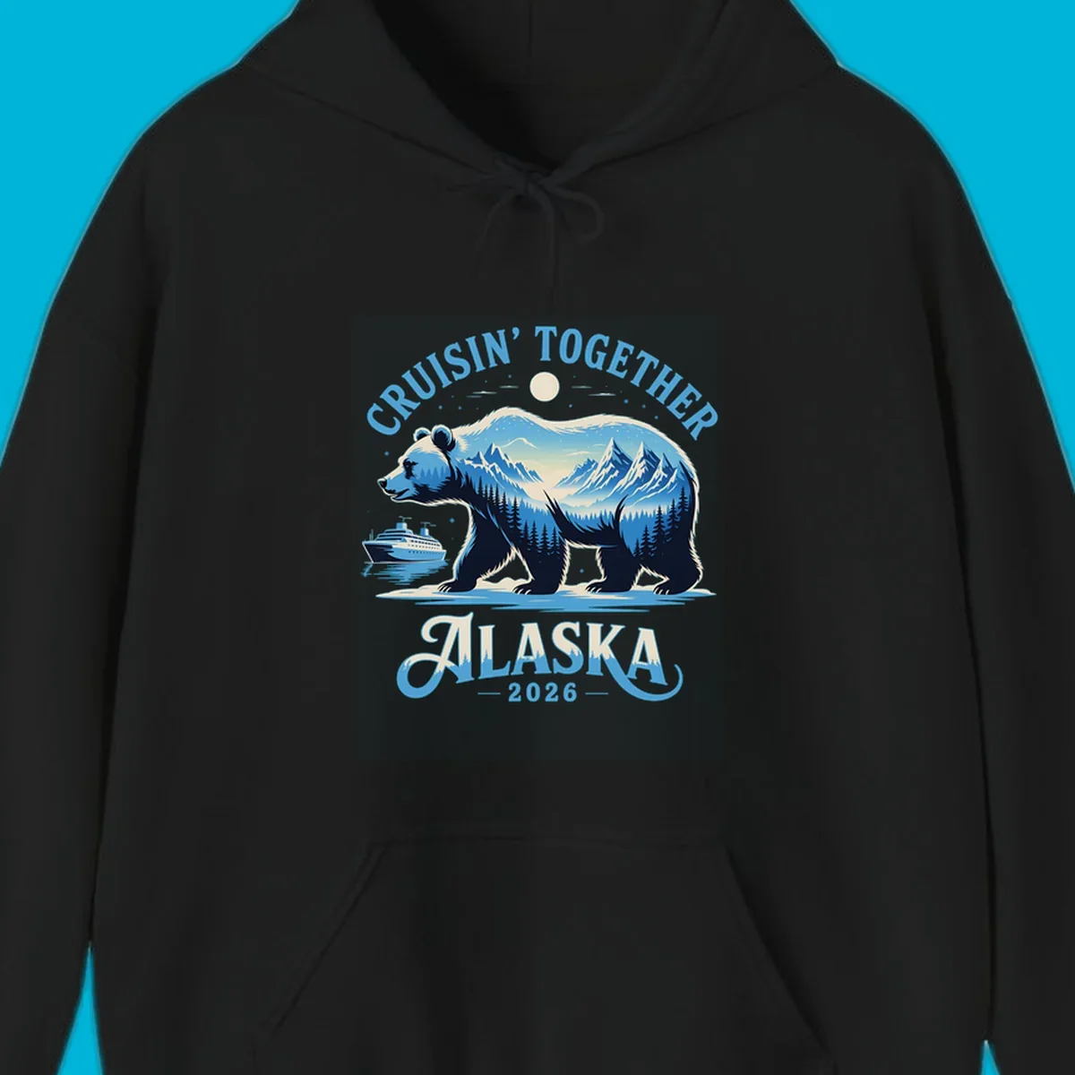 A stylized blue bear with mountains and trees inside its silhouette stands by a cruise ship. Text says 'CRUISIN' TOGETHER ALASKA 2026' for an alaska-cruise-bear-2026 design.