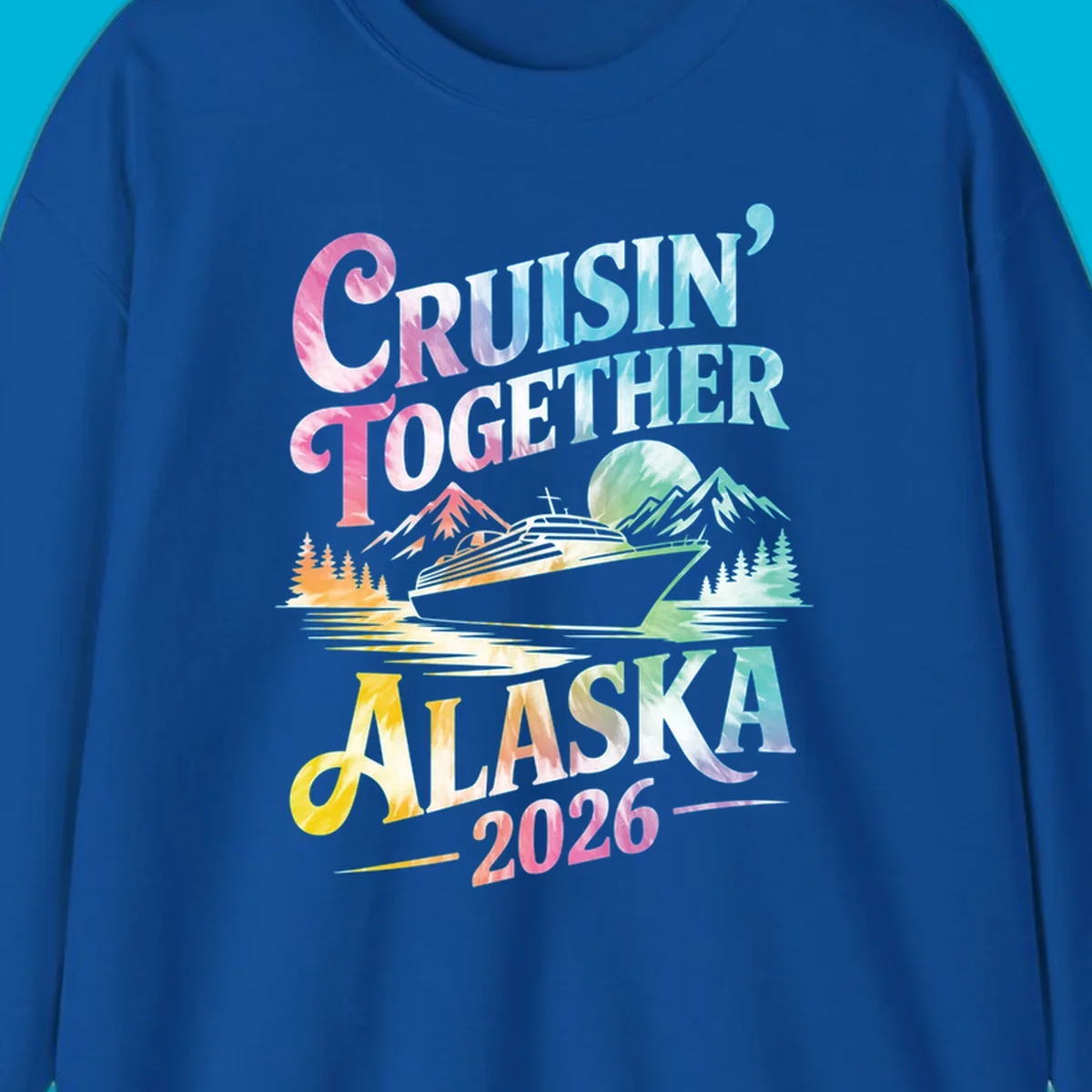 A tie-dye graphic featuring a cruise ship, mountains, and trees, with the text 'CRUISIN' TOGETHER ALASKA 2026'. This alaska-cruise-2026-tie-dye design shows a scenic view.