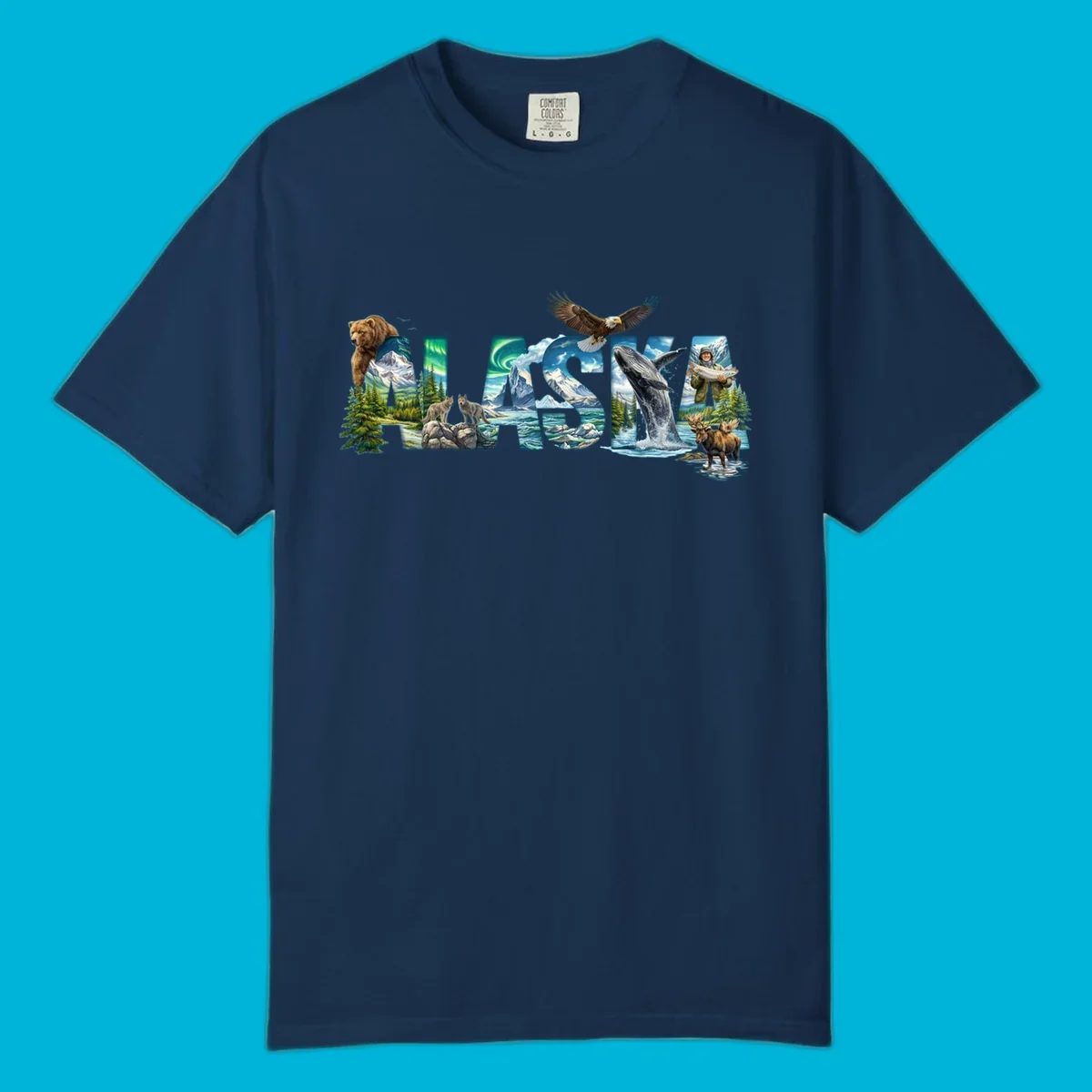 An illustrated text design spelling "ALASKA" with images of a grizzly, mountains, northern lights, wolves, ocean, bald eagle, whale, fisherman, and moose. This alaska-wildlife-scenic-text design captures the state's natural beauty.