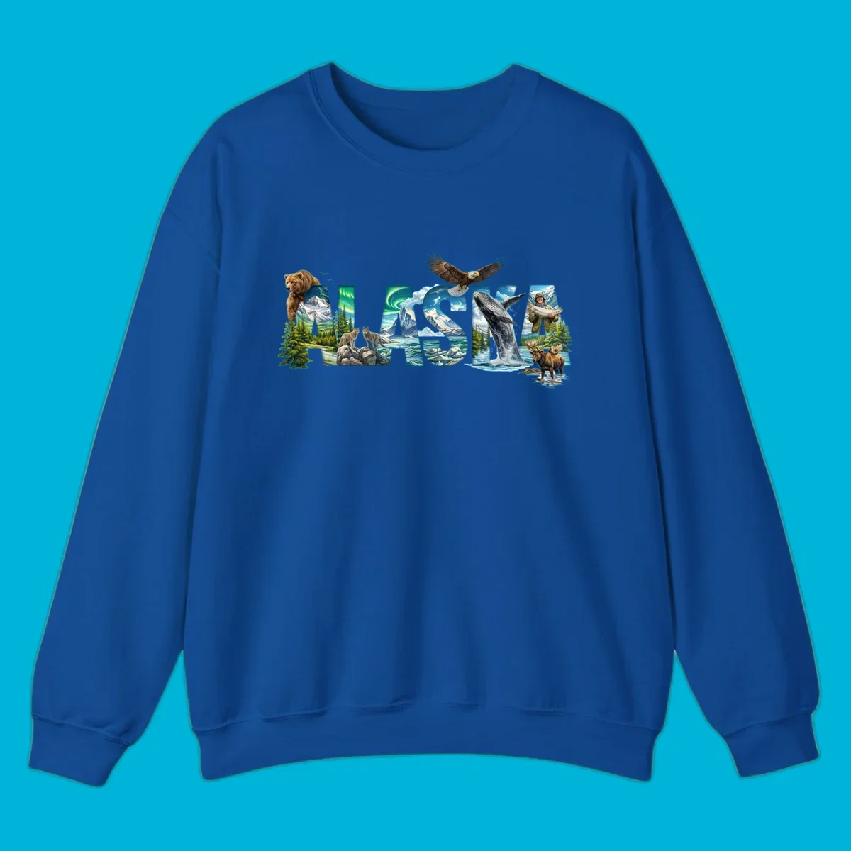 An illustrated text design spelling "ALASKA" with images of a grizzly, mountains, northern lights, wolves, ocean, bald eagle, whale, fisherman, and moose. This alaska-wildlife-scenic-text design captures the state's natural beauty.