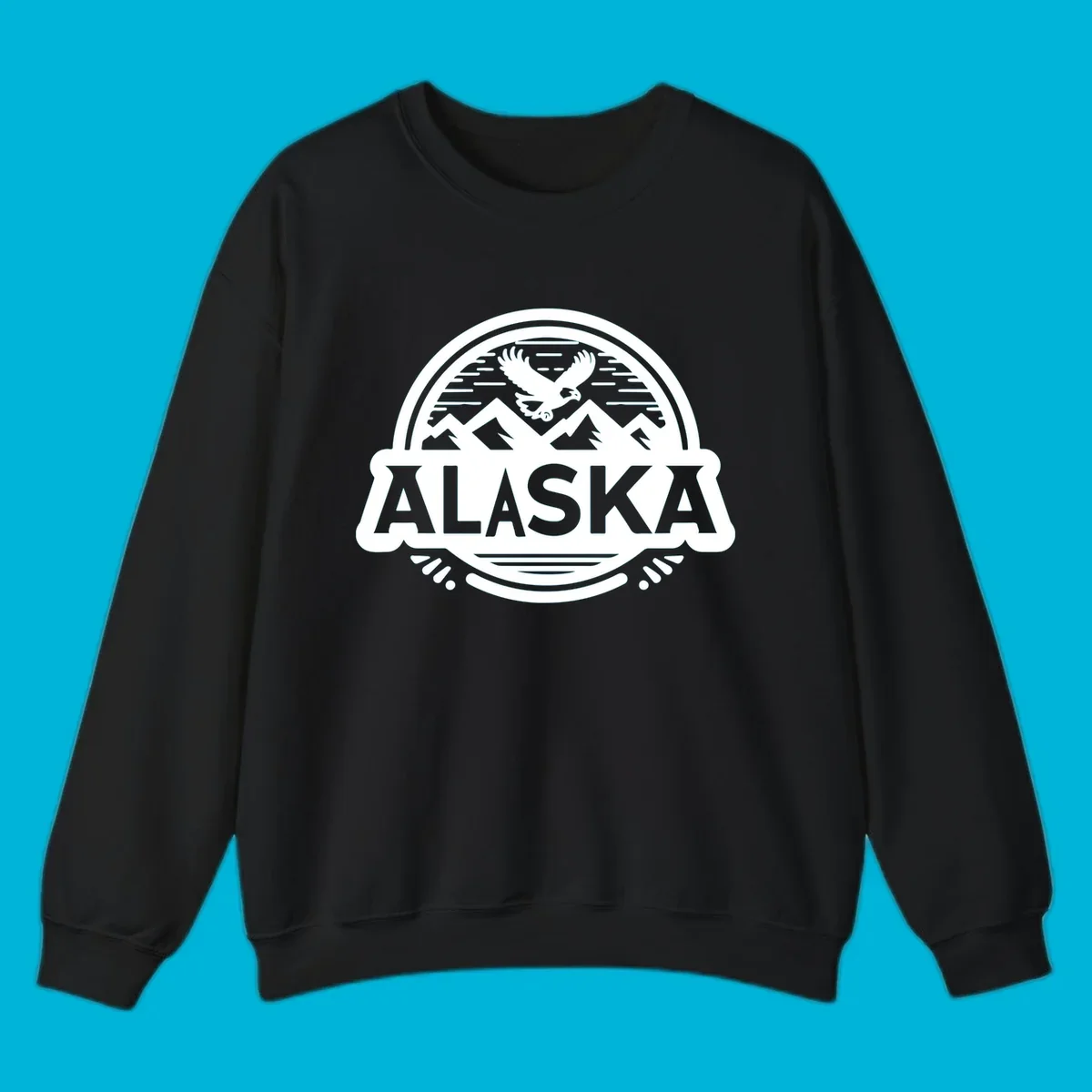 An oval badge design with a bald eagle flying above mountains and water, and the word ALASKA in bold text; alaska-eagle-mountain-badge.