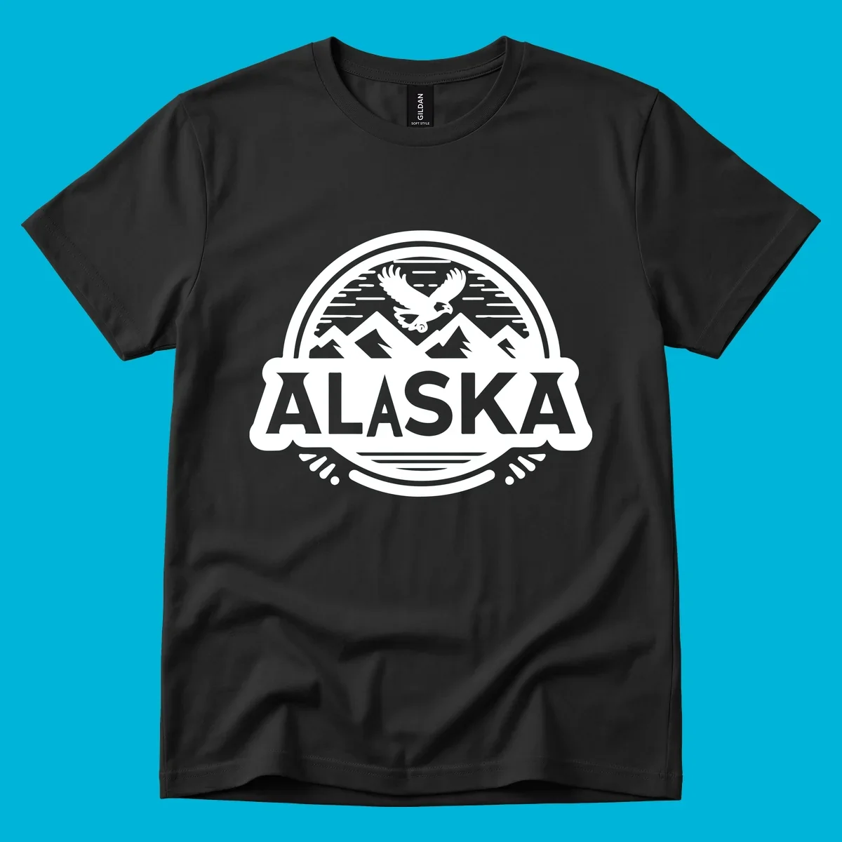 An oval badge design with a bald eagle flying above mountains and water, and the word ALASKA in bold text; alaska-eagle-mountain-badge.