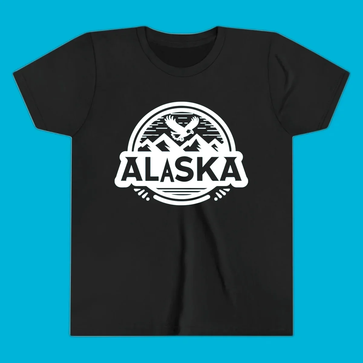 An oval badge design with a bald eagle flying above mountains and water, and the word ALASKA in bold text; alaska-eagle-mountain-badge.