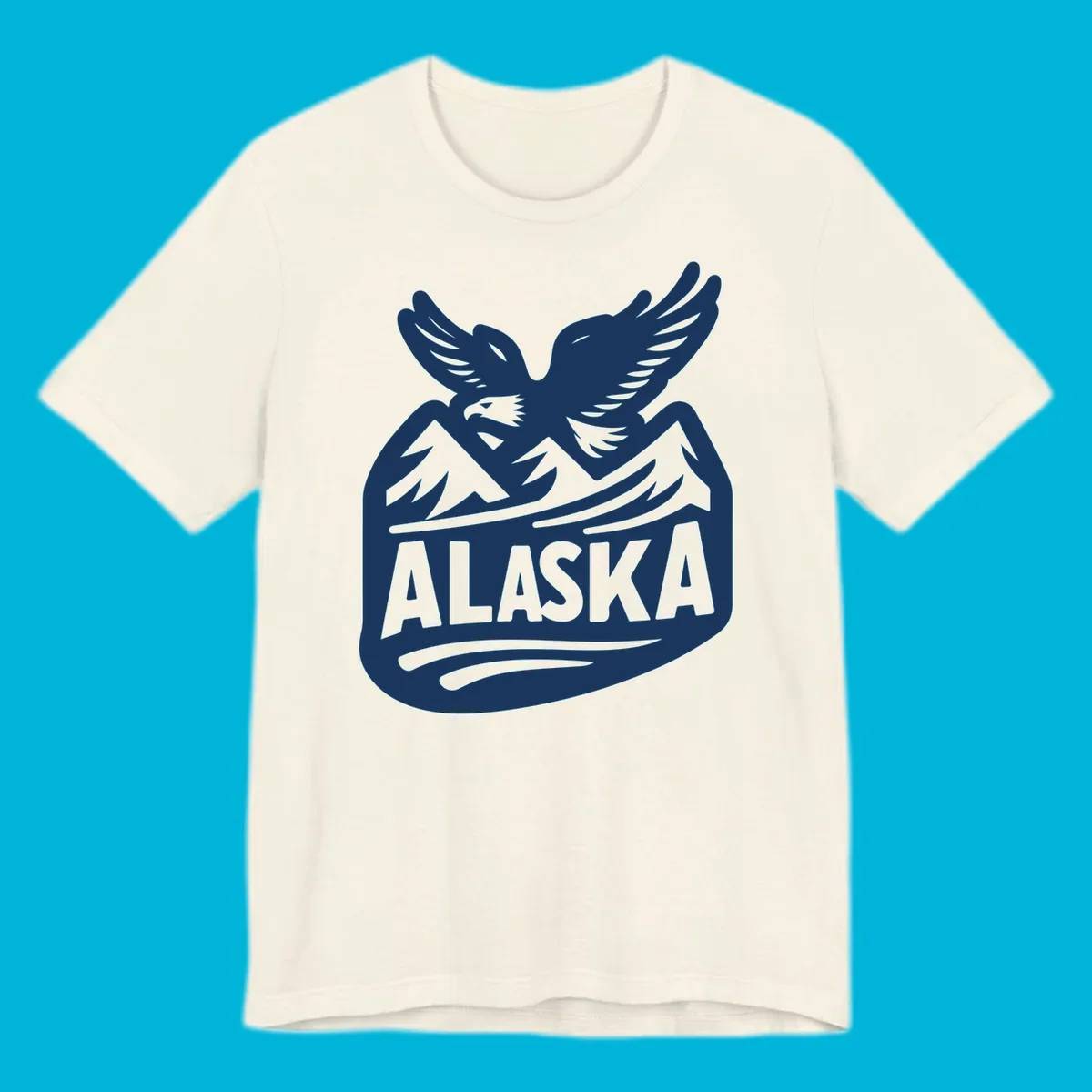 A white and dark blue badge design showing a flying eagle over mountain peaks with "ALASKA" text, for a cruise souvenir.