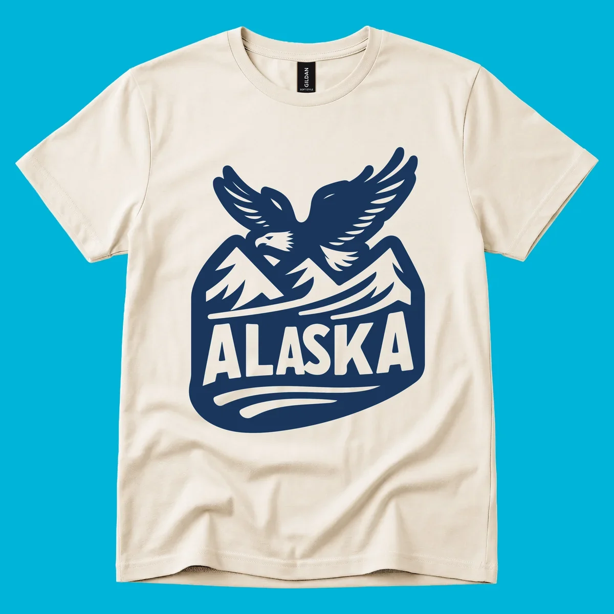A white and dark blue badge design showing a flying eagle over mountain peaks with "ALASKA" text, for a cruise souvenir.
