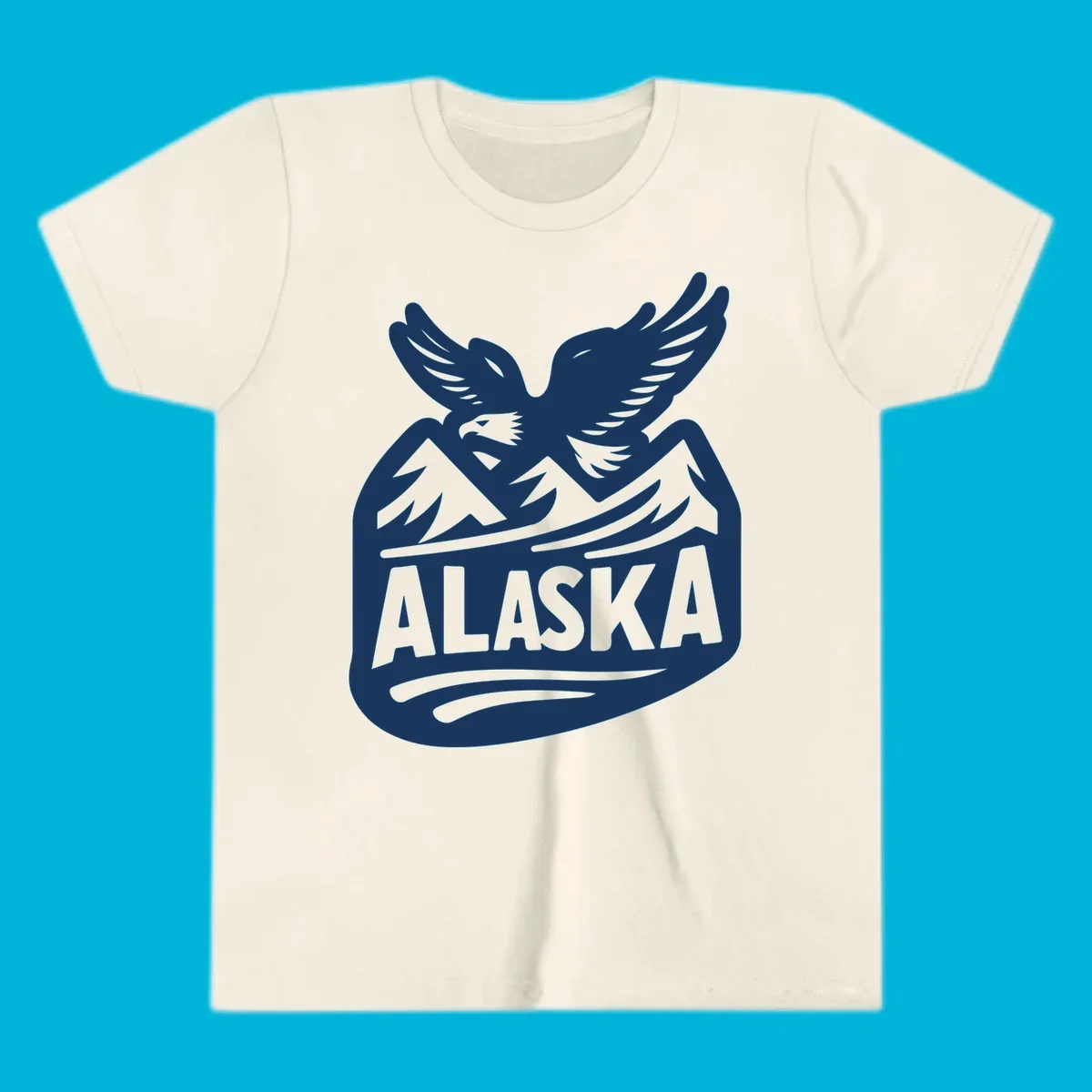 A white and dark blue badge design showing a flying eagle over mountain peaks with "ALASKA" text, for a cruise souvenir.