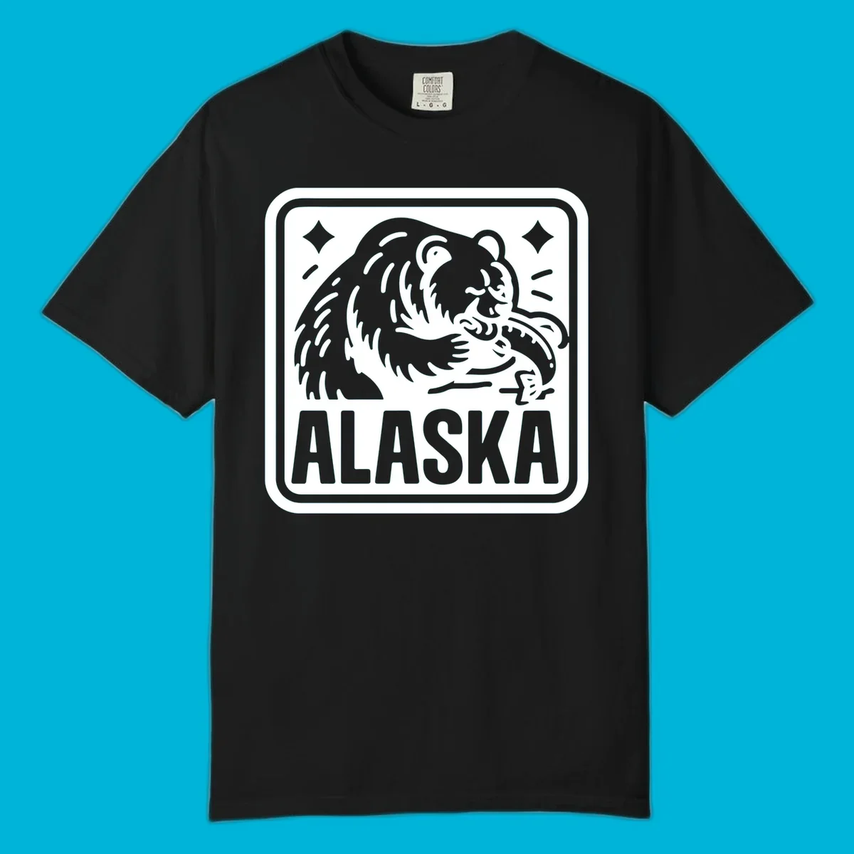 A white alaskan grizzly salmon fishing illustration within a rectangular badge, with 'ALASKA' text.