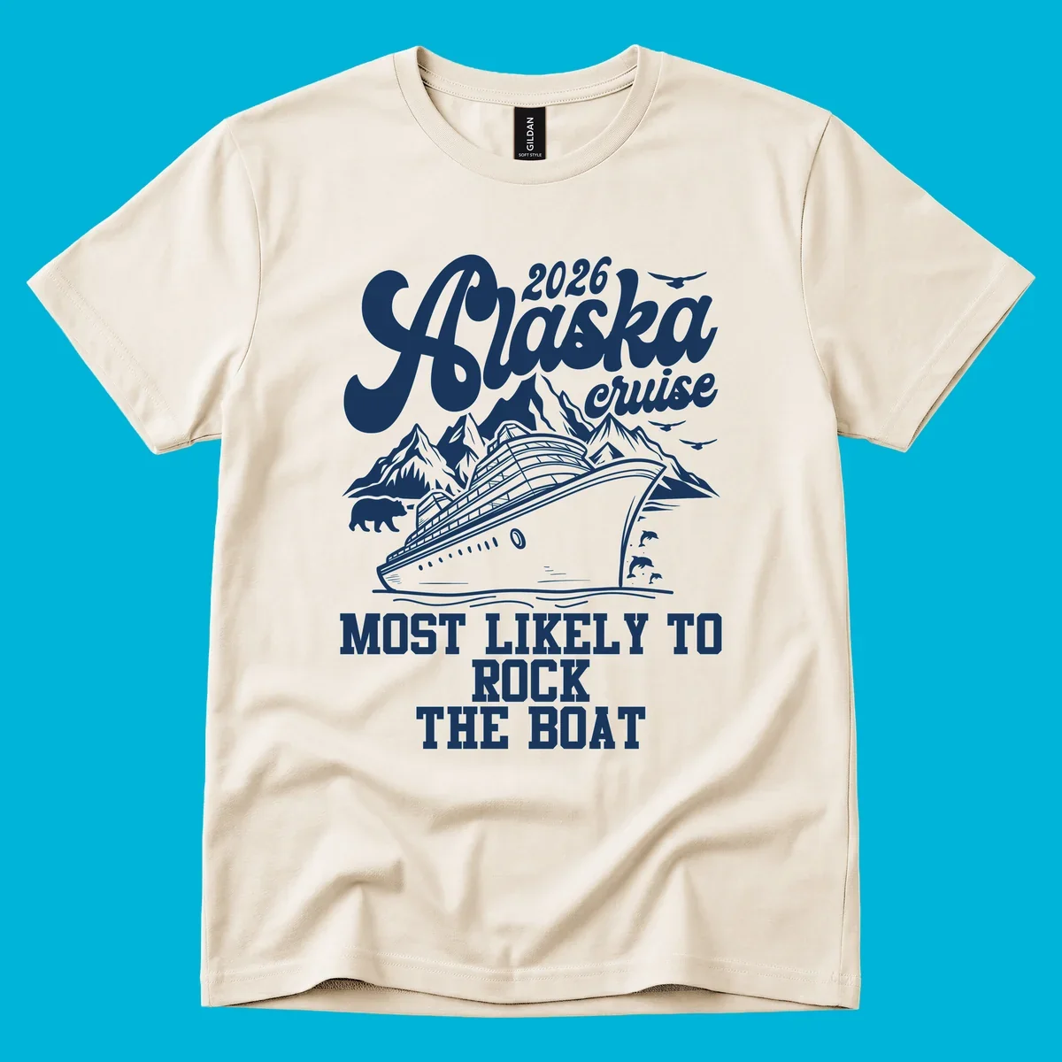 An illustrated Alaska cruise rock the boat design with a ship, mountains, bear, dolphins, and birds.