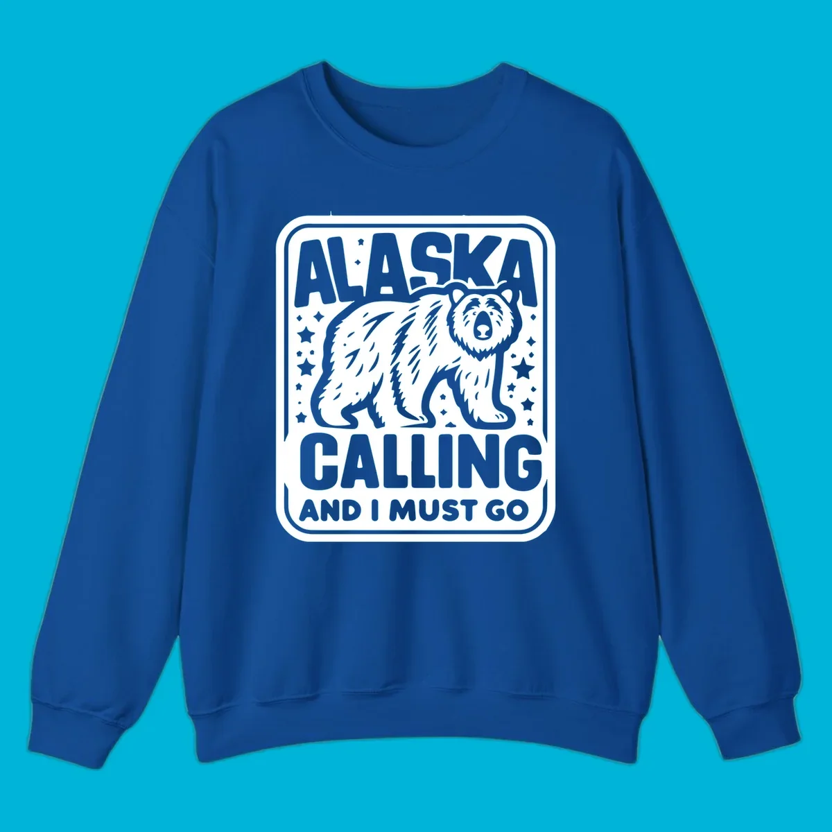 A vintage-style illustration of a bear with stars and the text 'ALASKA CALLING AND I MUST GO'.