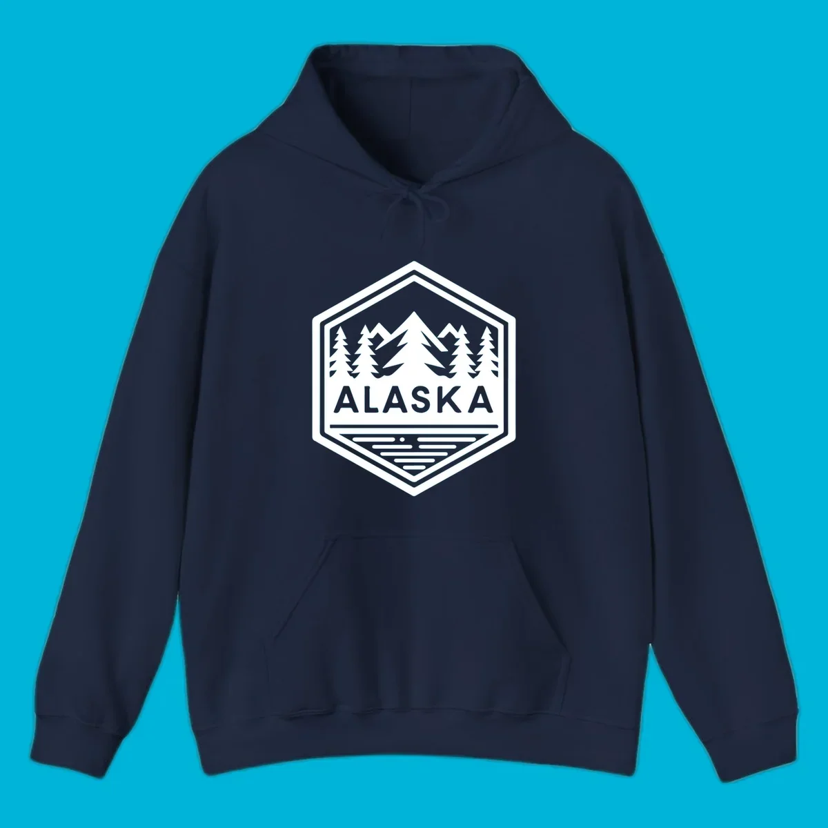 An Alaska mountain lake badge design in a hexagon shape, showing mountains, pine trees, and a lake below the ALASKA text.
