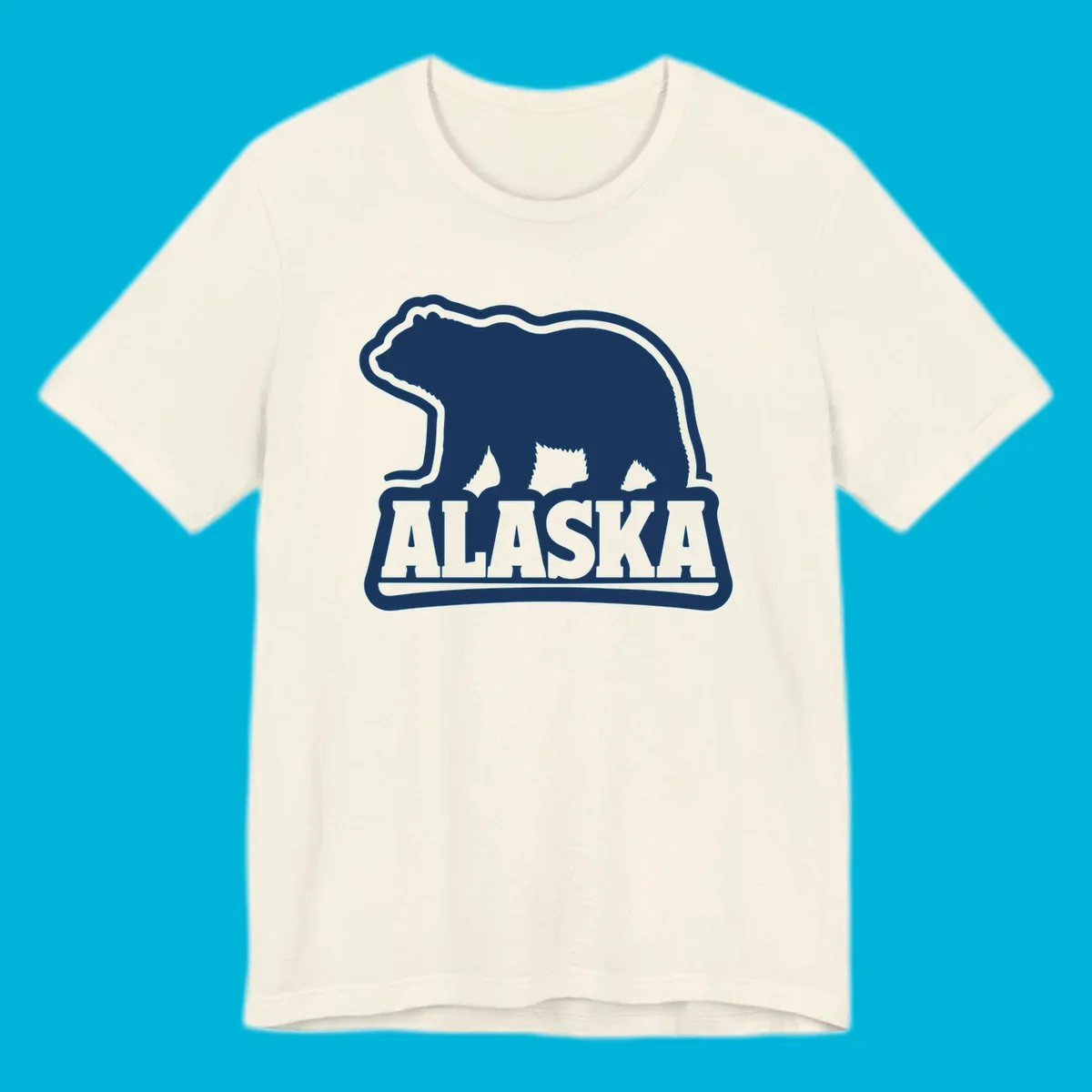 A vintage Alaska bear emblem featuring a navy bear silhouette above the word ALASKA, all with a white outline.