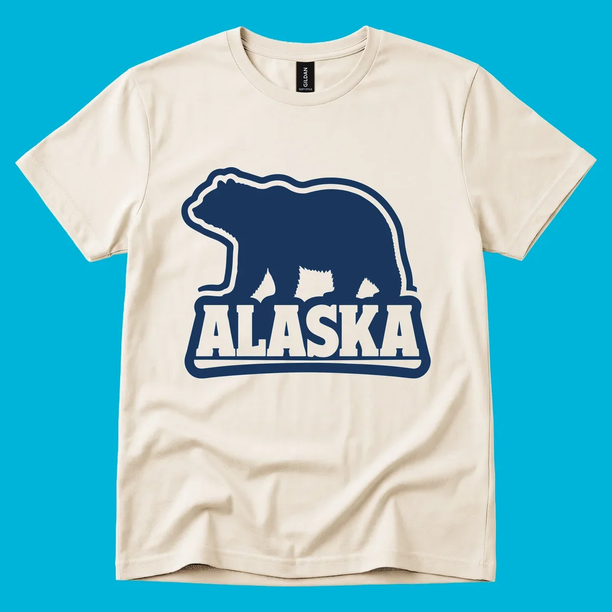 A vintage Alaska bear emblem featuring a navy bear silhouette above the word ALASKA, all with a white outline.