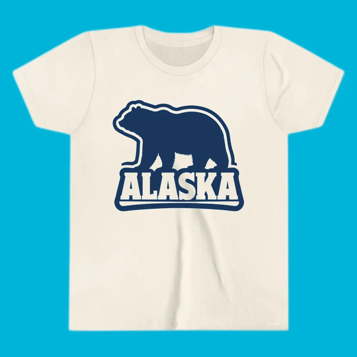 A vintage Alaska bear emblem featuring a navy bear silhouette above the word ALASKA, all with a white outline.