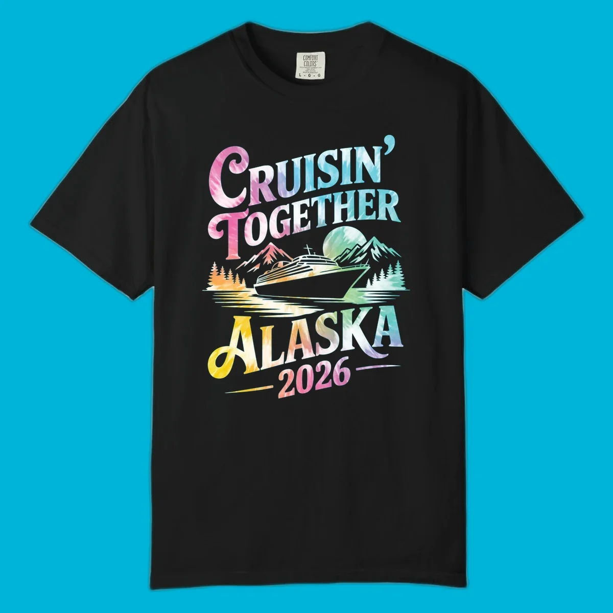 A tie-dye graphic featuring a cruise ship, mountains, and trees, with the text 'CRUISIN' TOGETHER ALASKA 2026'. This alaska-cruise-2026-tie-dye design shows a scenic view.