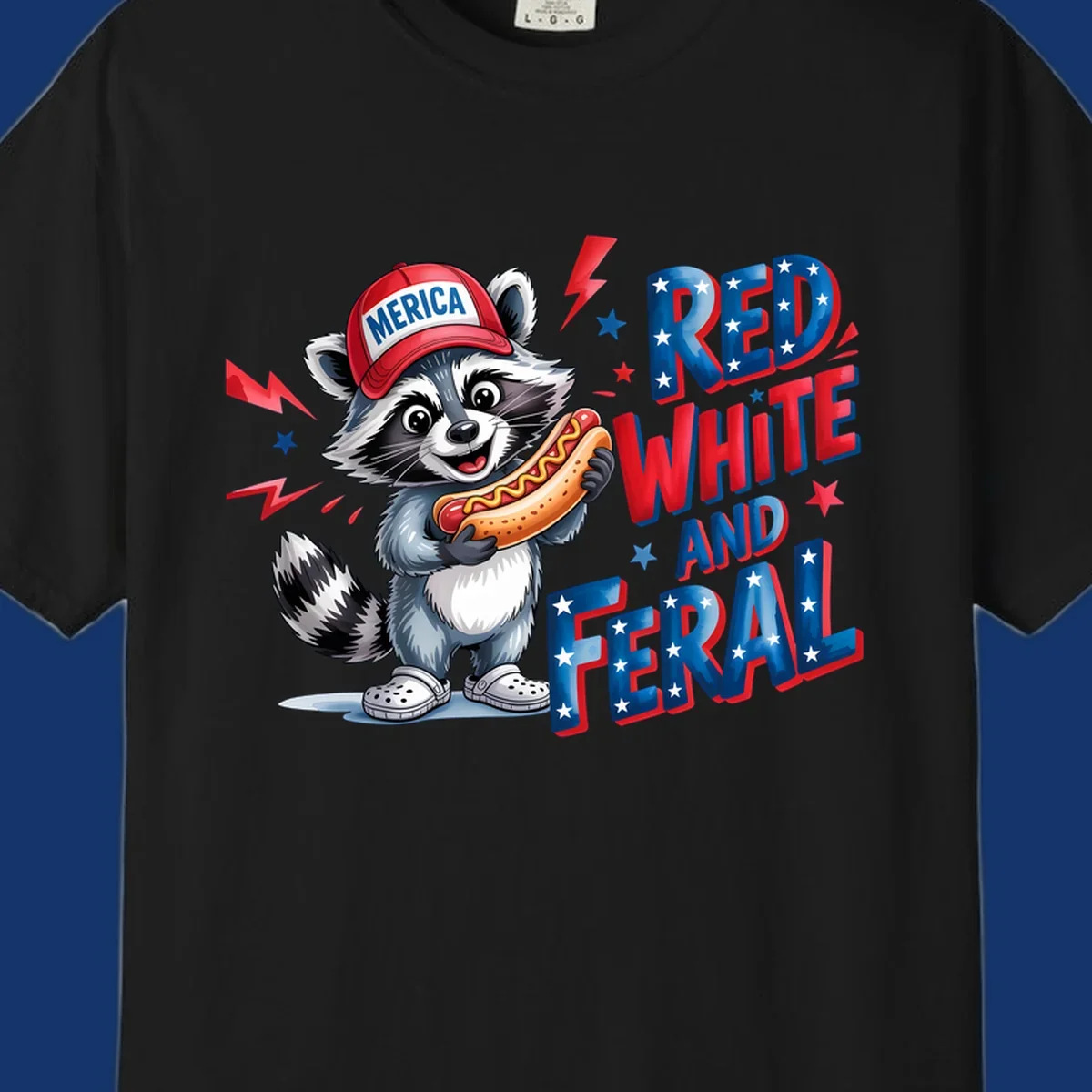A cartoon raccoon wearing a 'MERICA' hat and holding a hot dog, next to text 'RED WHITE AND FERAL'. This is a raccoon-red-white-feral design.