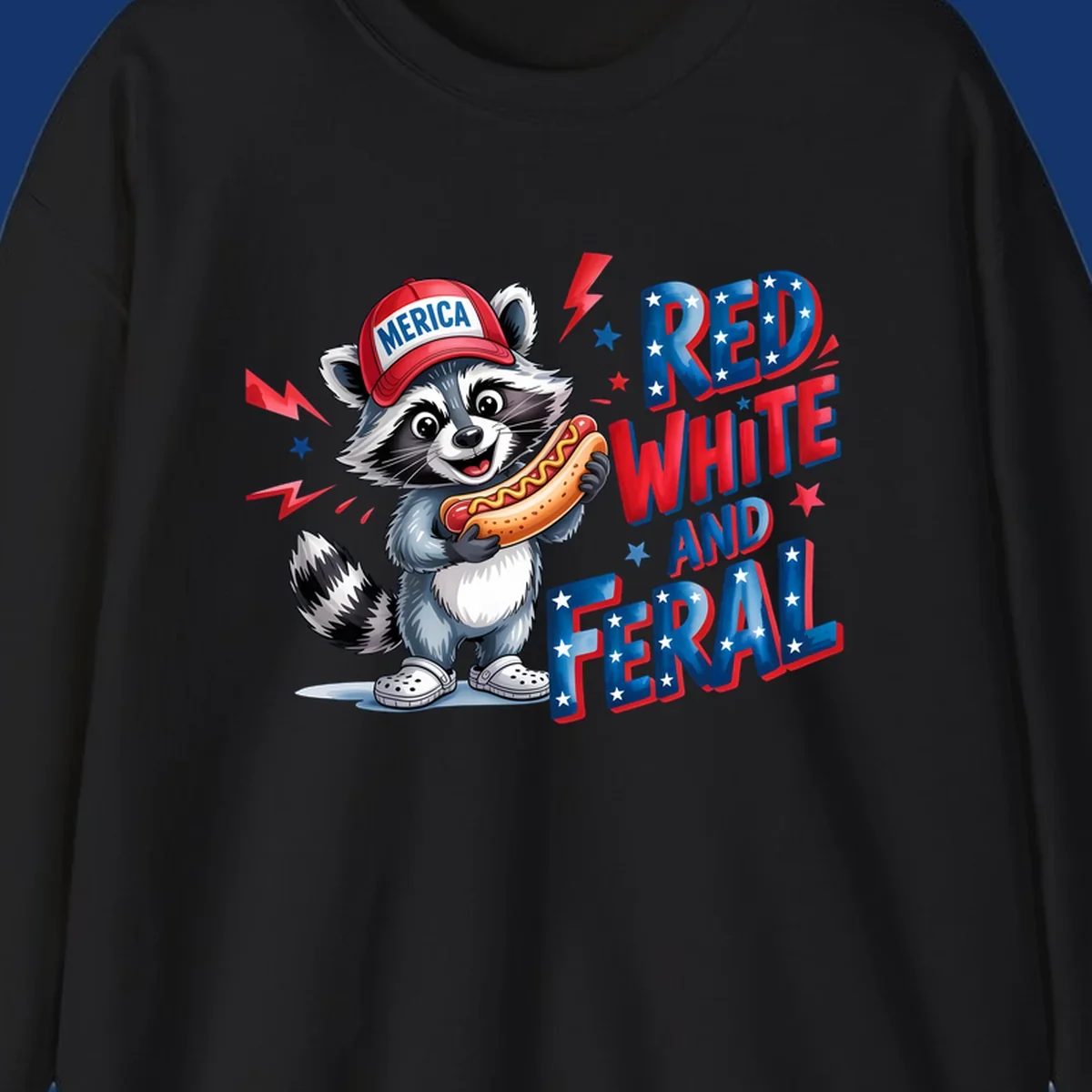 A cartoon raccoon wearing a 'MERICA' hat and holding a hot dog, next to text 'RED WHITE AND FERAL'. This is a raccoon-red-white-feral design.