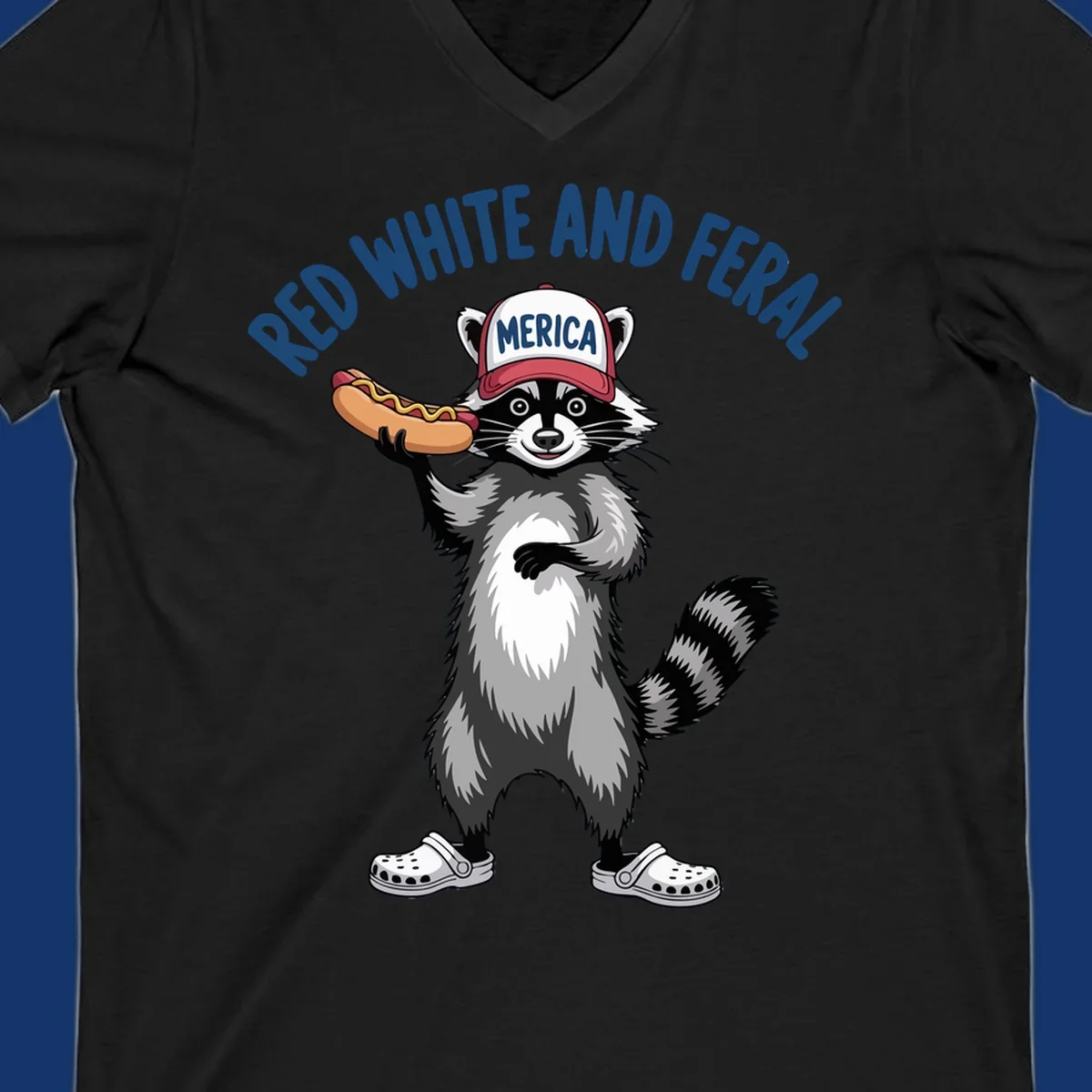 A patriotic raccoon in a MERICA hat and Crocs holds a hot dog, with 'RED WHITE AND FERAL' text. Features the red-white-feral-raccoon concept.